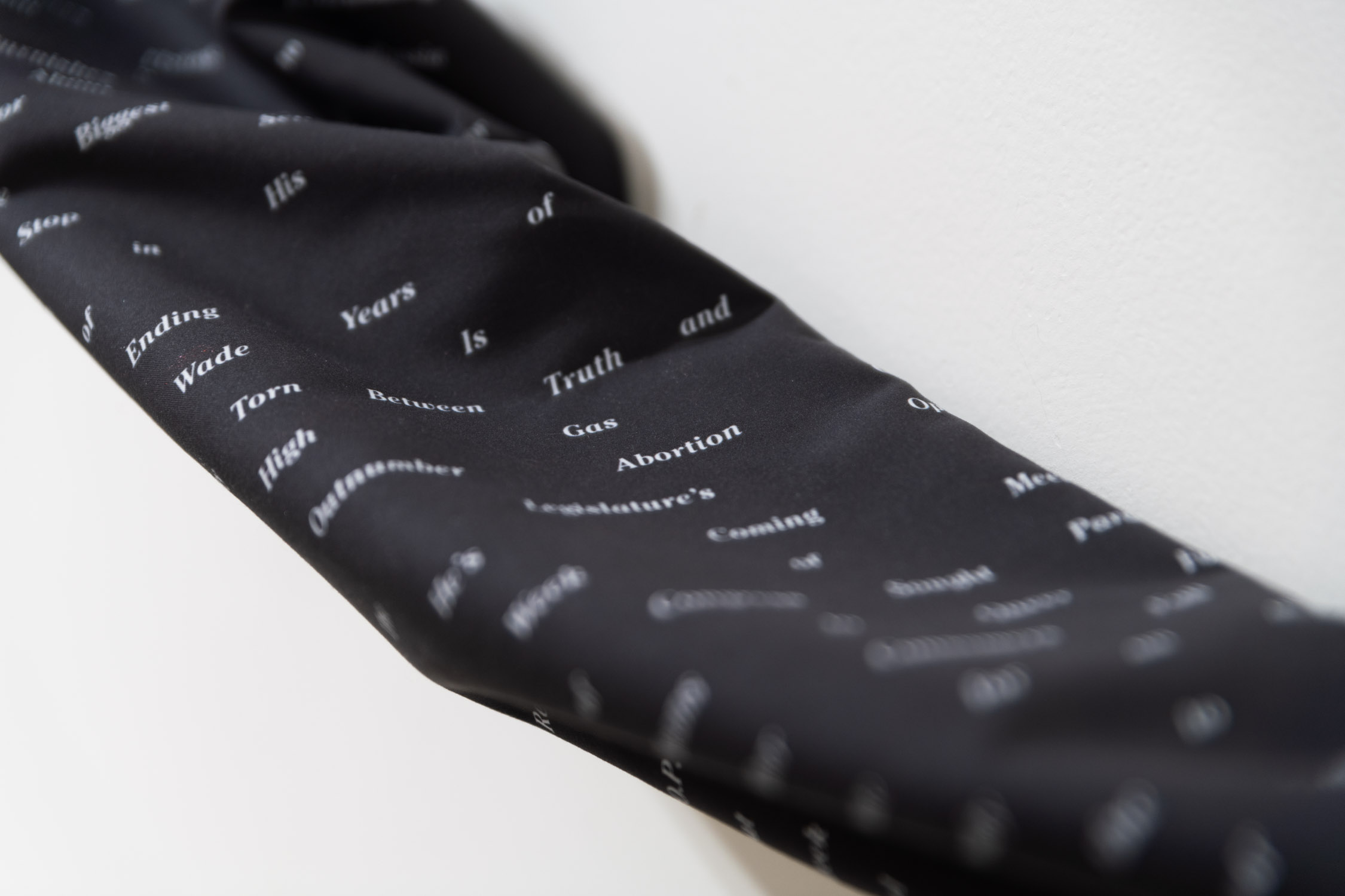 'Context Collusion: June 23-25, 2022'. Midgray, 2022. New York Times headlines arranged in a bell curve via artificial intelligence sentiment analysis. Digital print on fabric. 324 x 24 in.