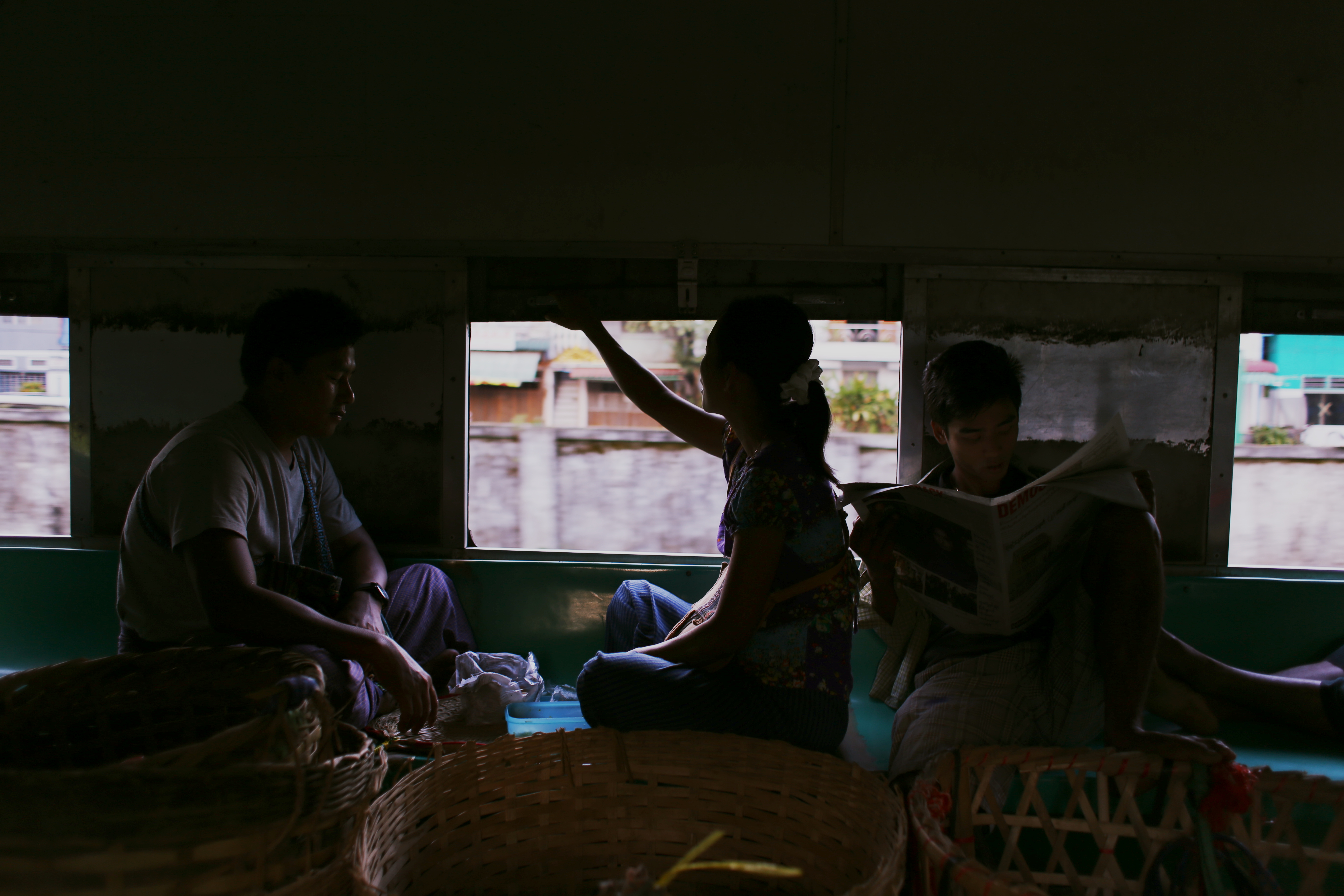 On their way to work, a trading family enjoys a meal on the train surrounded by their wicker baskets. They pass around a thin local Burmese-language newspaper titled Democracy Today. The daily 32-page tabloid was launched in February this year as a reincarnation of The Yangon Times. It costs 100 kyats and gets tossed out the window after they've finished reading.