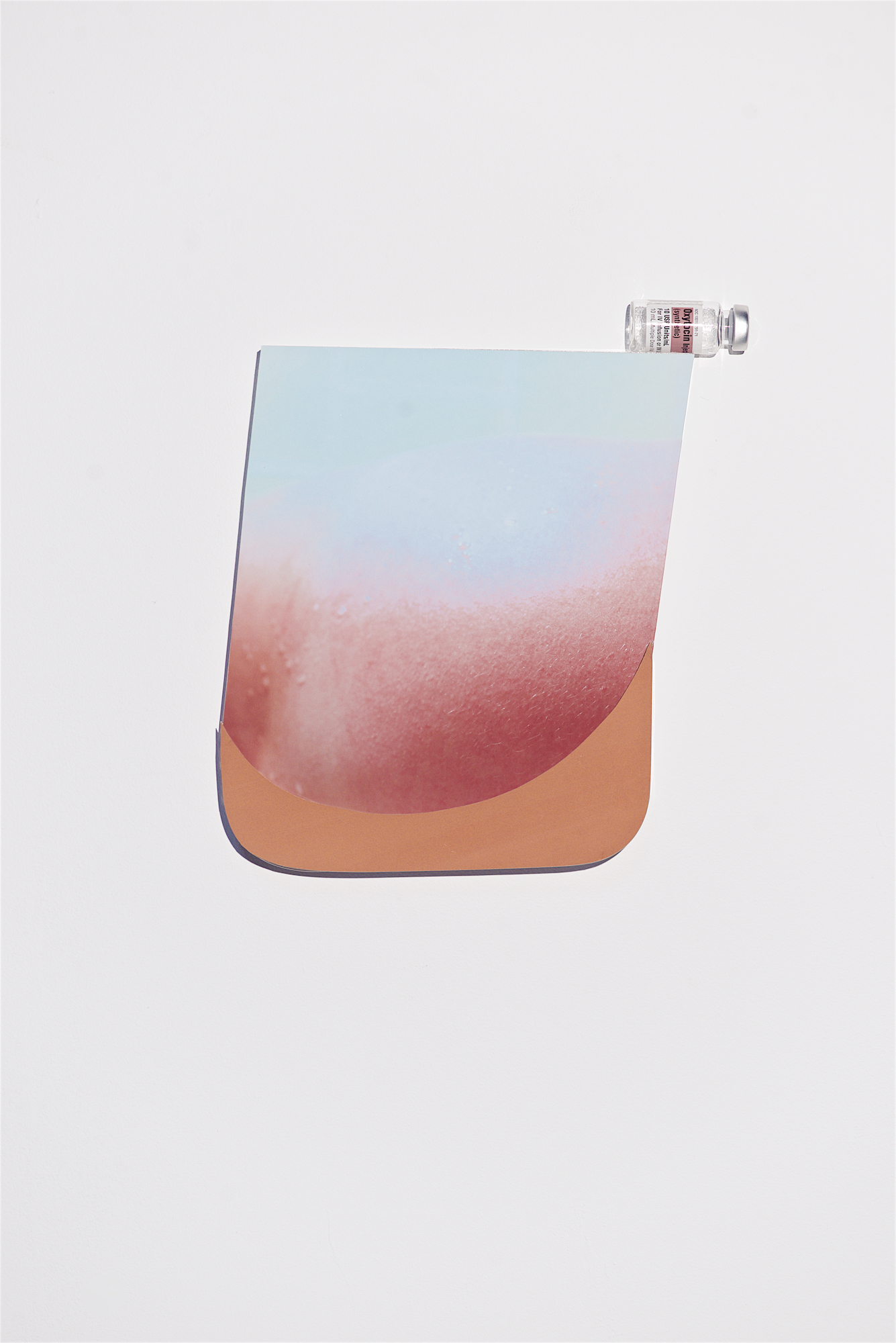 New enlightened era COMING SOON with earthy brown, 2018, gouache, archival ink-jet print, oxytocin, glass bottle, mounted on acrylic glass, approx. 13” x 10”
