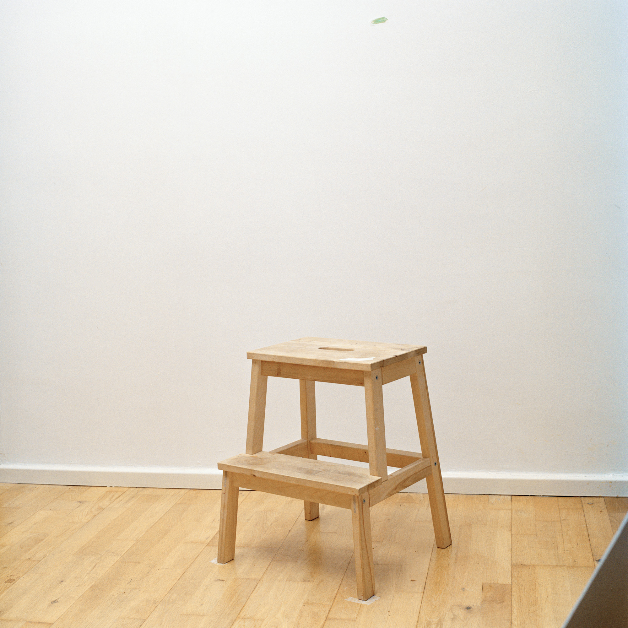 Photograph of a chair in front of a white wall shot by UK-based photographer Ilayda Akarca