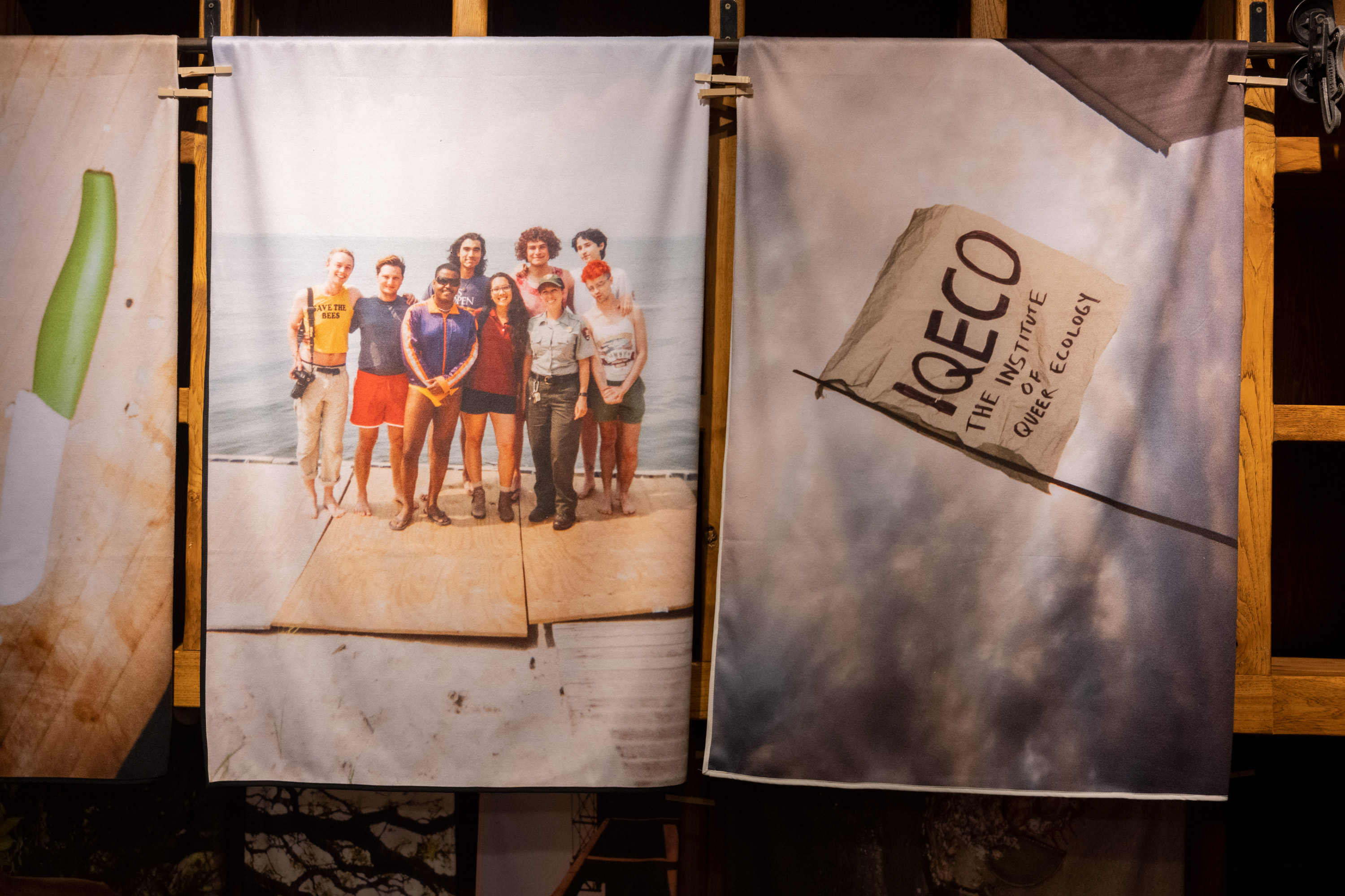 The Symbiotic Shore: Excerpts from IQECO Fire Island Image Archive (2019), Various Artists for the Institute of Queer Ecology. 44 towels, each 33 x 57 in (83.82 x 144.8 cm) Installation view of “The Symbiotic Shore” a group exhibition curated by the Institute of Queer Ecology (2021). Photo by Lee Pivnik. Courtesy of the Institute of Queer Ecology, Bas Fisher Invitational and Bridge Initiative.