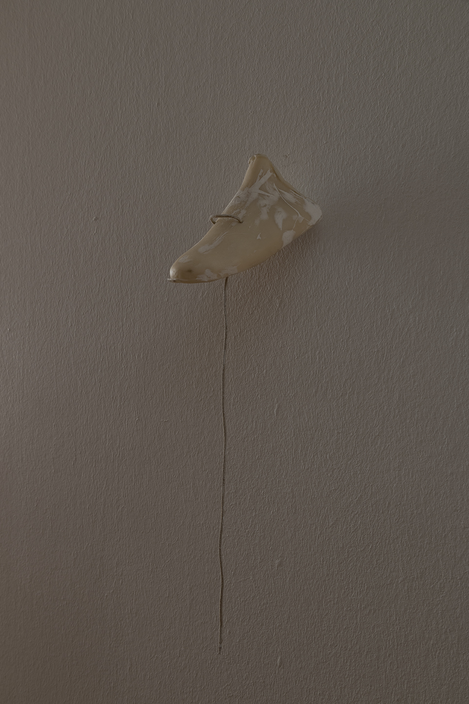 Bystander (Thread), 2025. Air-dry porcelain, wood filler, shoe lace. 8 x 16,5 x 7,5 cm