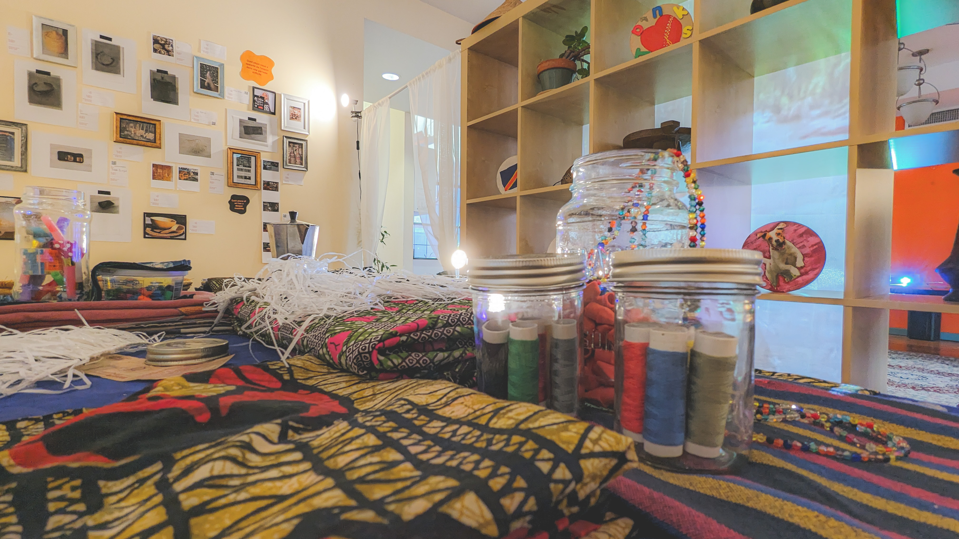 Fabrics from participants homes helped tie the space together with their objects of hope including beads, ethnic dresses, a carafe in the foreground.