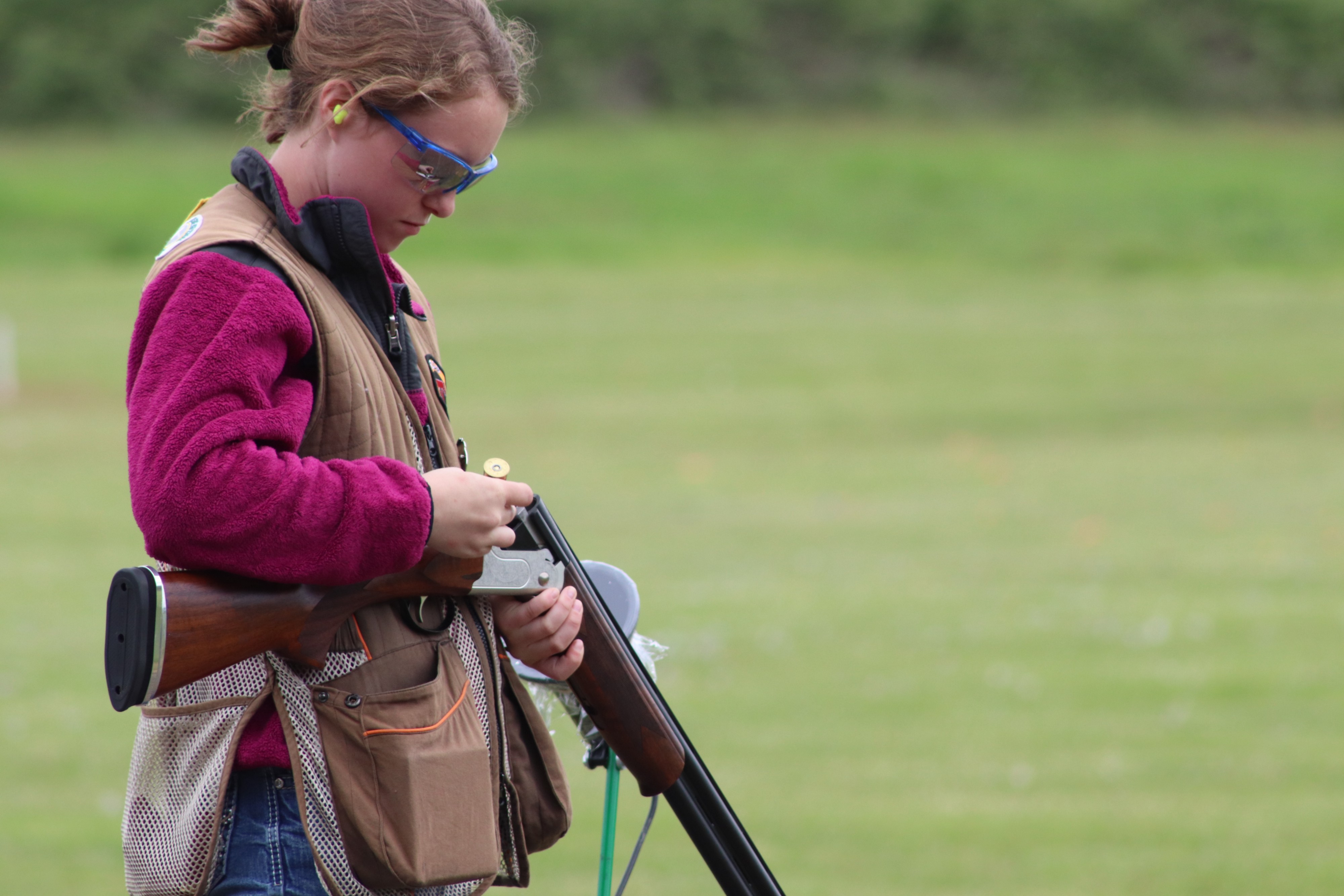 Vivian Seaholm carefully reloads her shotgun at the Tillamook Gun Club.