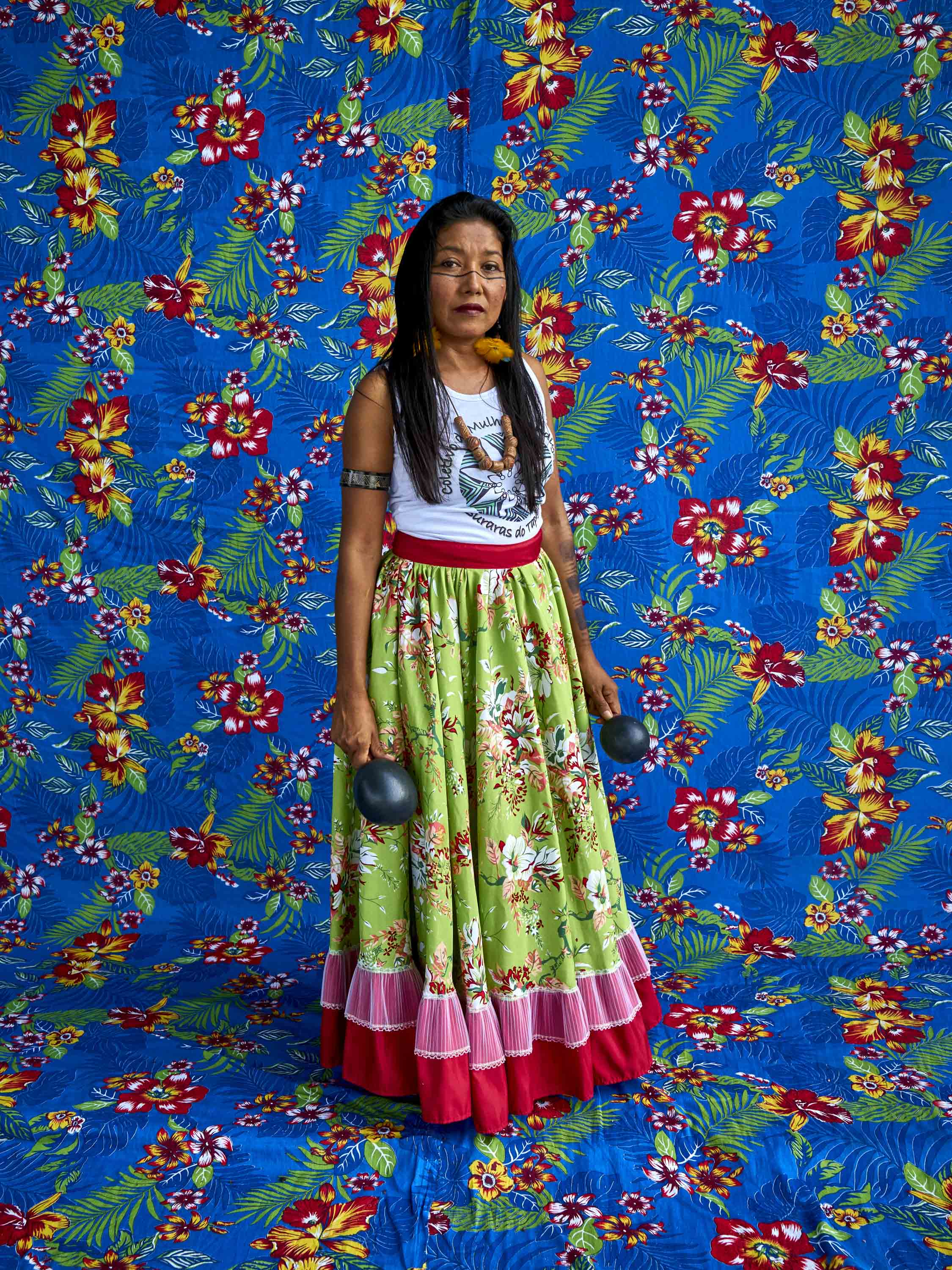 Neila Borari is part of the Suraras do Tapajós group. She poses for the portrait with her coconut-made rattles.