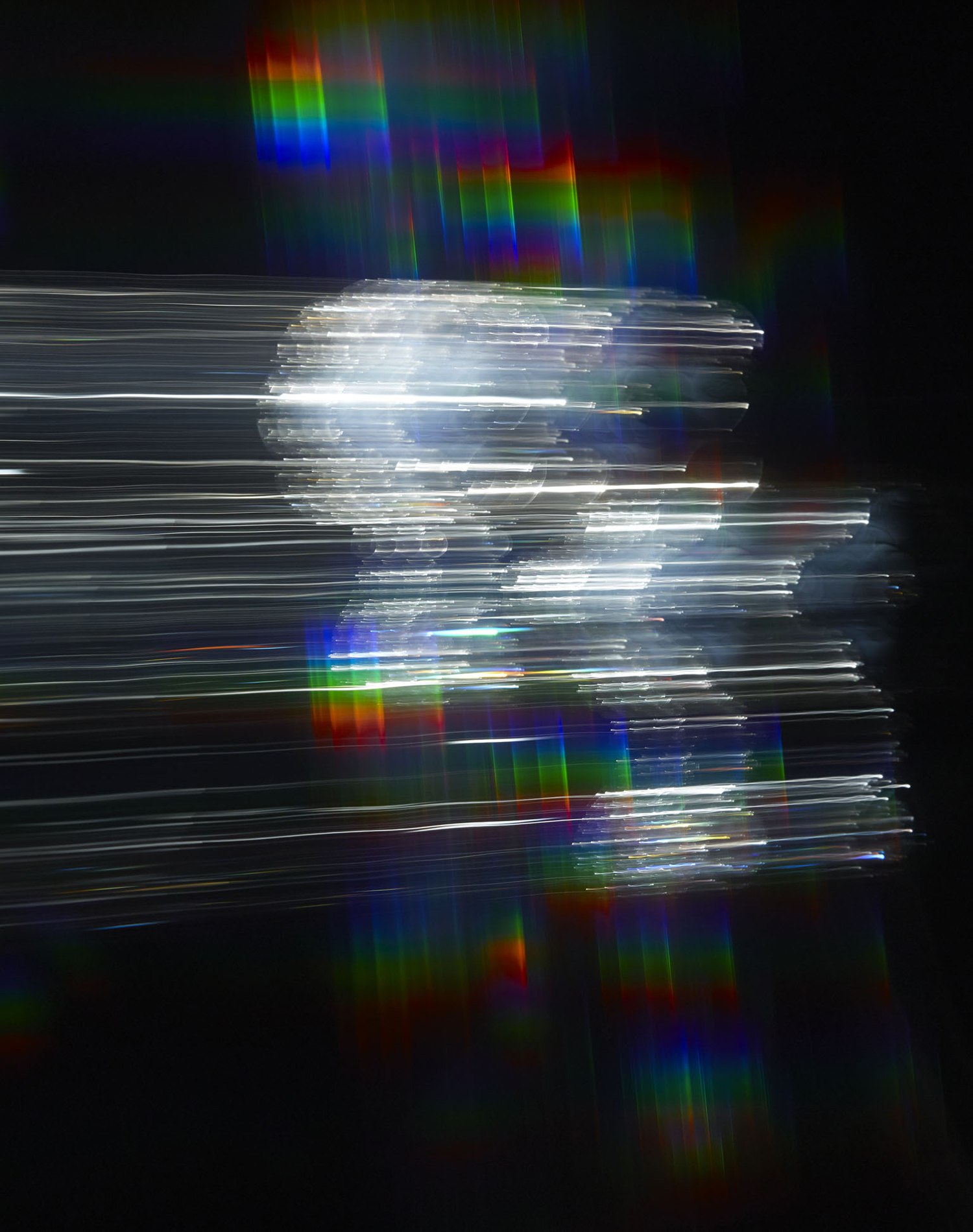 KMA photographer Daniel Schweizer shoots an abstract photo of rainbow lights flashing against a black background