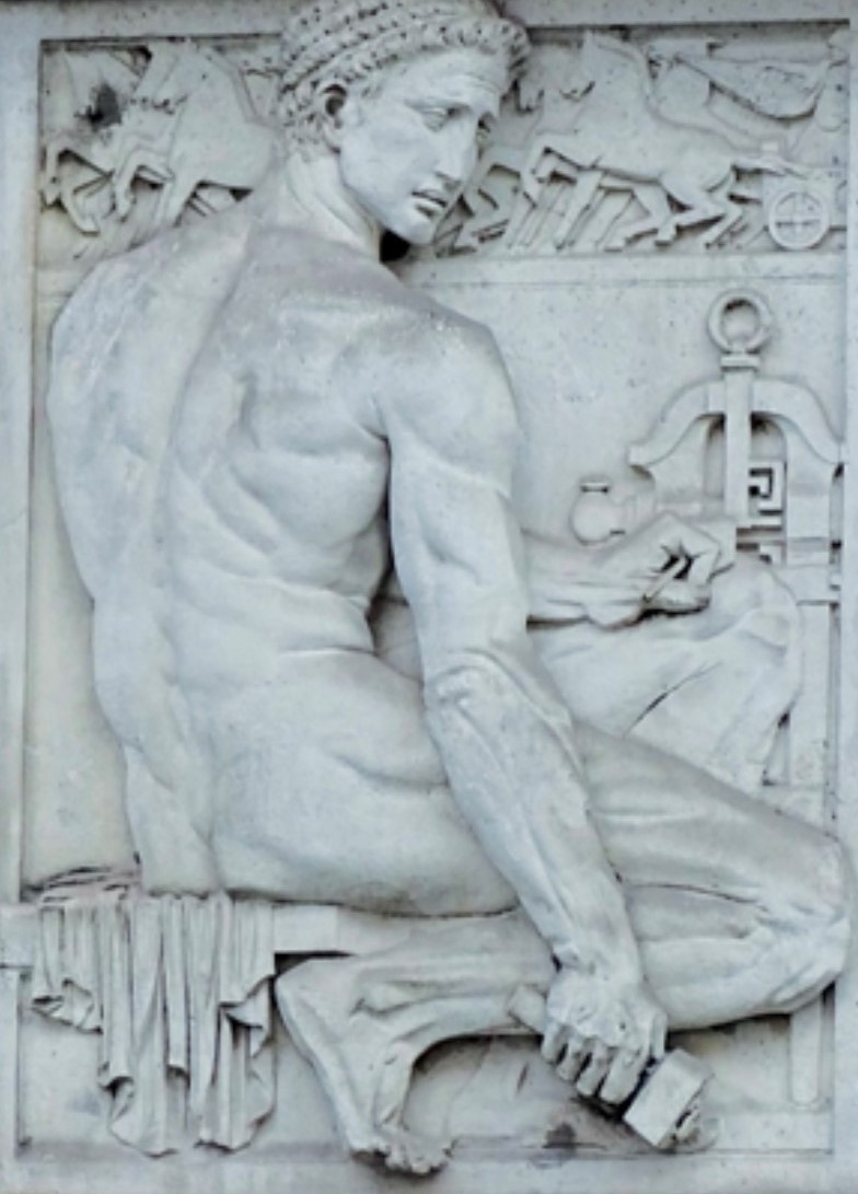 19-21 Hatton Garden. Architectural detail depicting a goldsmith with hammer and mills.