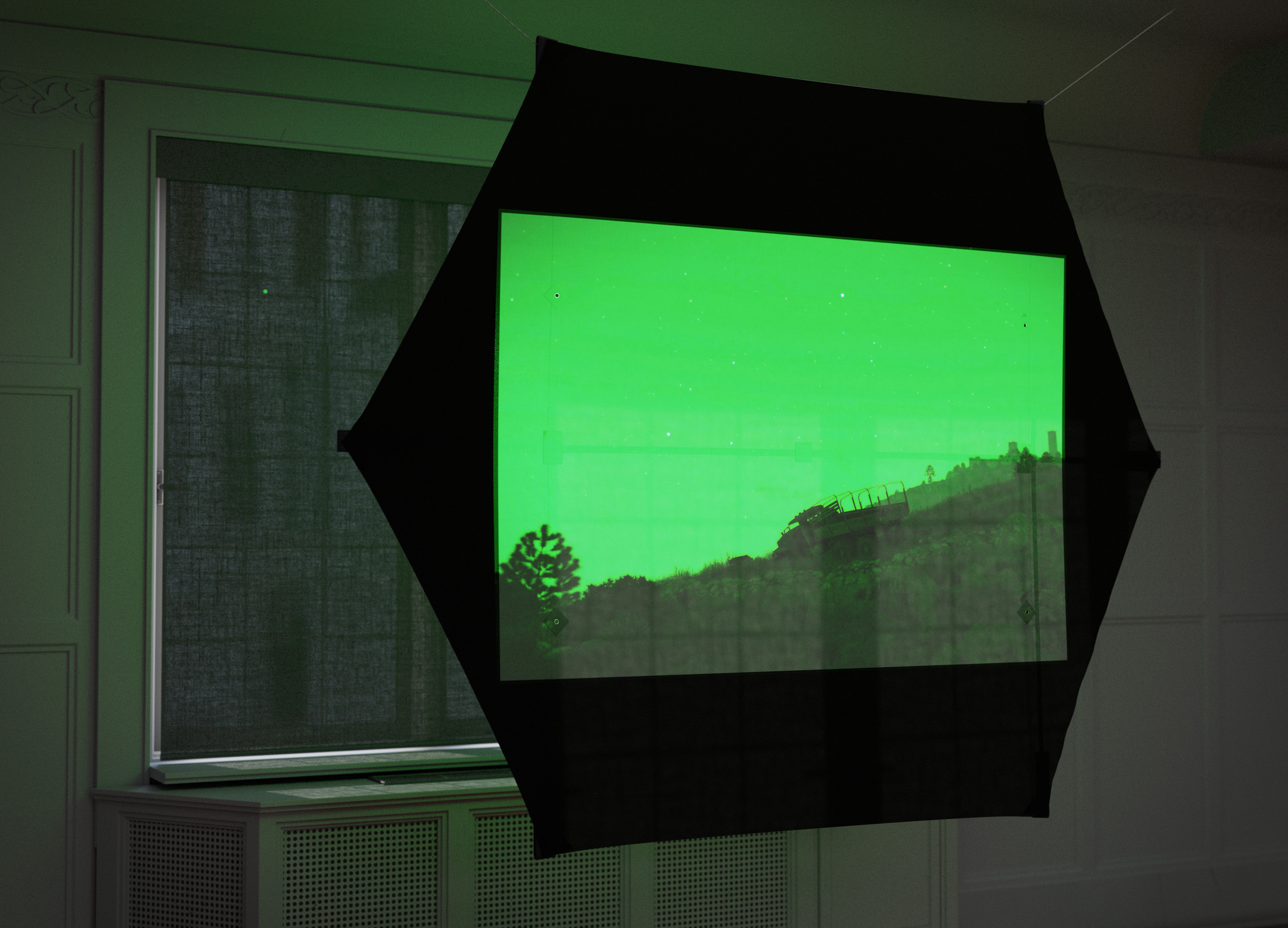 Simulation Sickness, 2025, slide projector, target gong with stand, ethically-sourced painted turtle shell, digital wind instruments, tactile transducers, rokkaku kite, aircraft cable, tape, wiring, amplifiers, midi interface, patch cords, hardware, dimensions variable