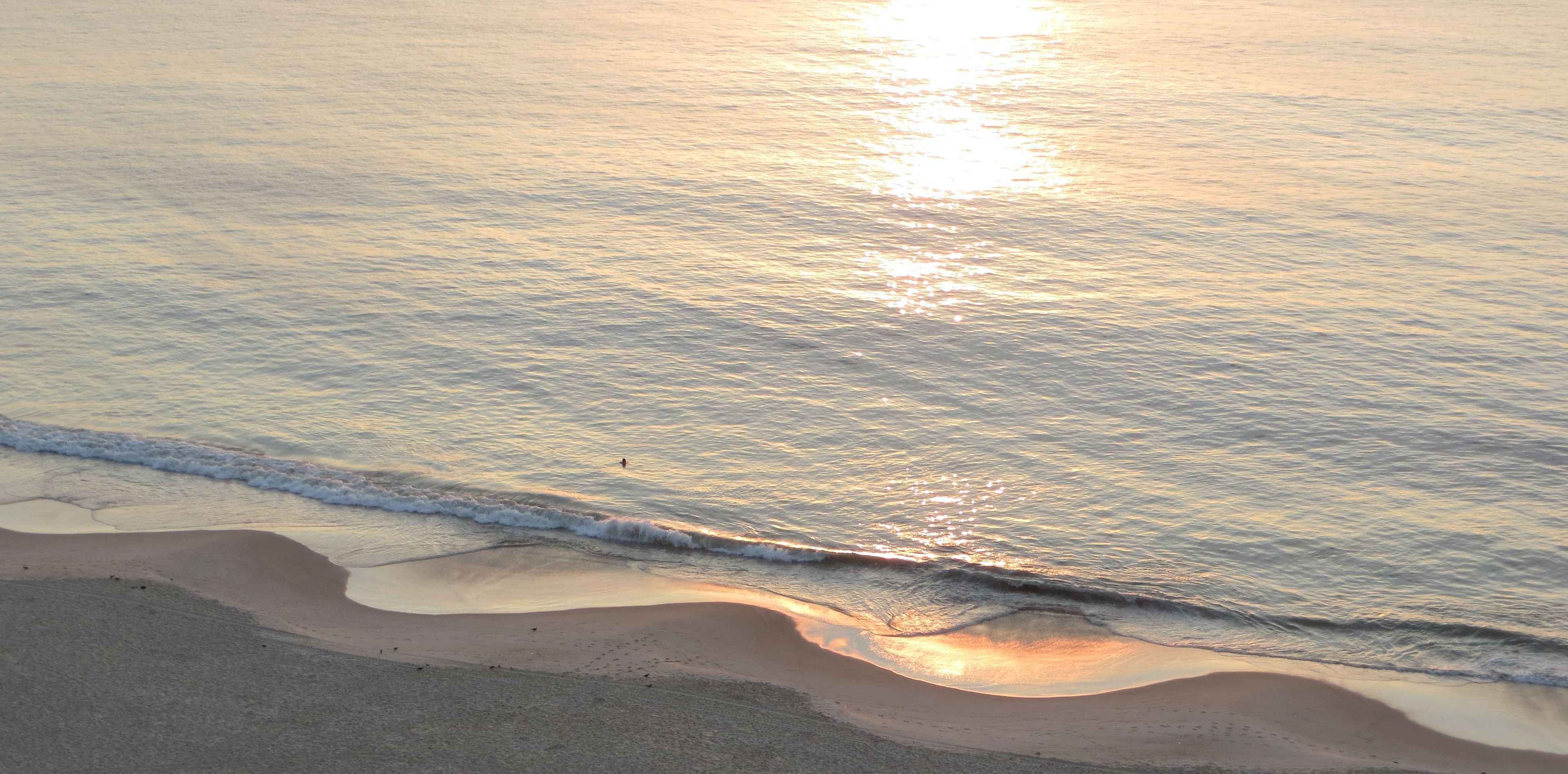 Notice not only the waves on the surface of the water but also the wave pattern of the coast line: interference of the waves and the sand created this surprisingly regular pattern.