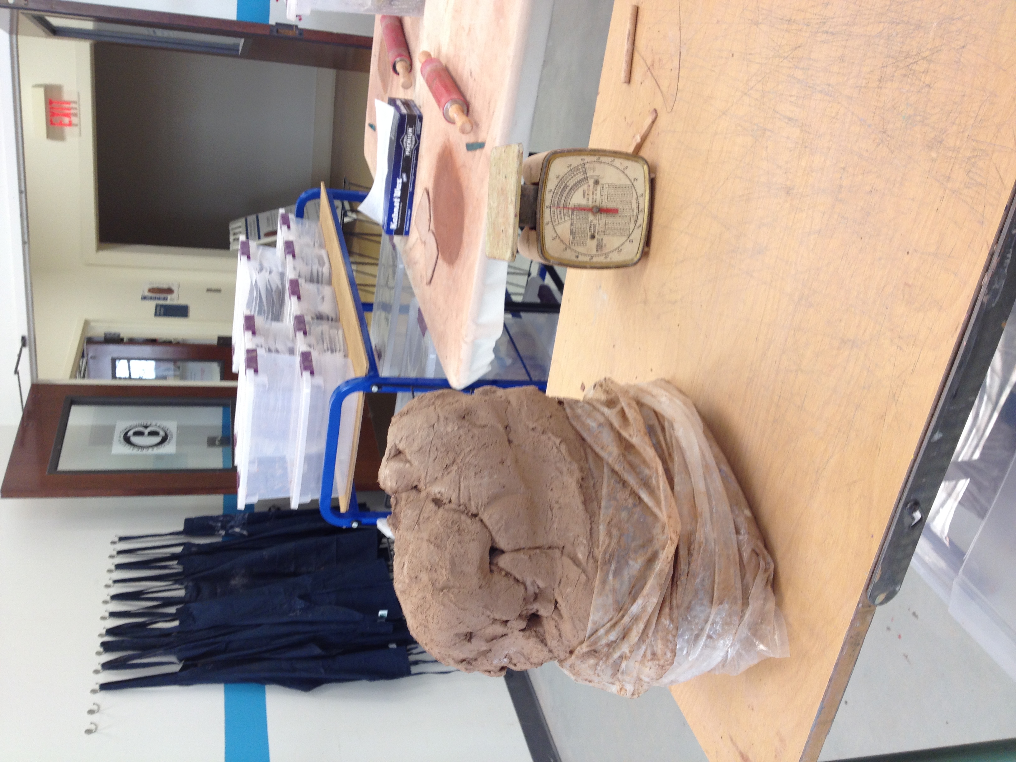 the weigh station - so many plastic boxes to keep clay from drying while moving through the assembly line