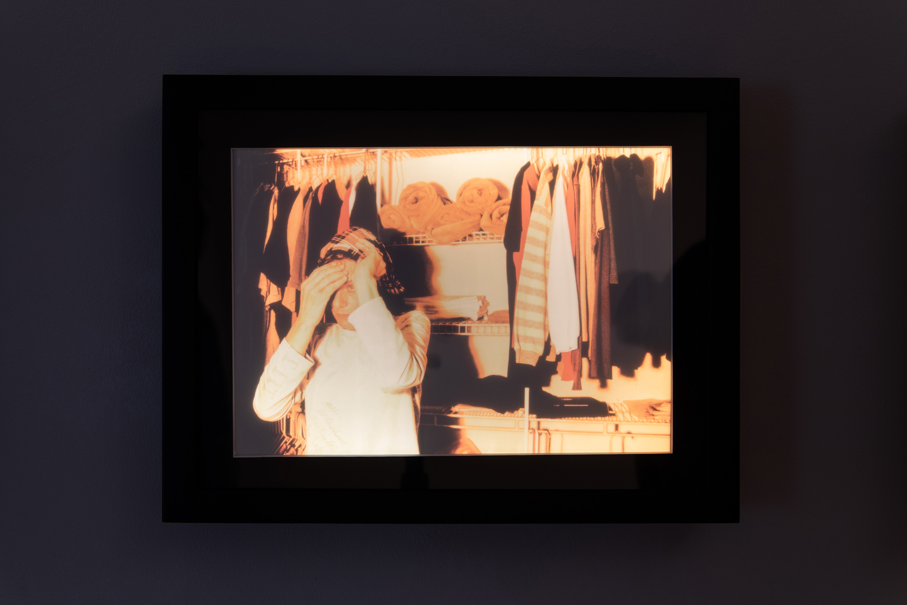"Althea in her wardrobe I," 2008 (printed 2022), transparency in LED lightbox, 9" x 12" x 1"