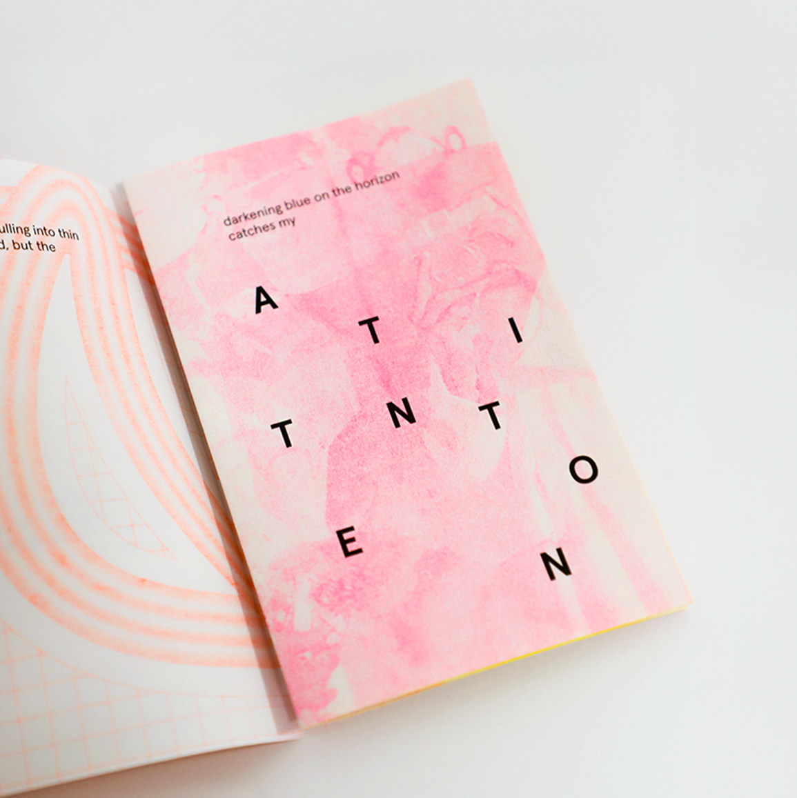 Pink and organge risograph page with capital letters spelling "attention" scattered across the page, visually illustrating the text.