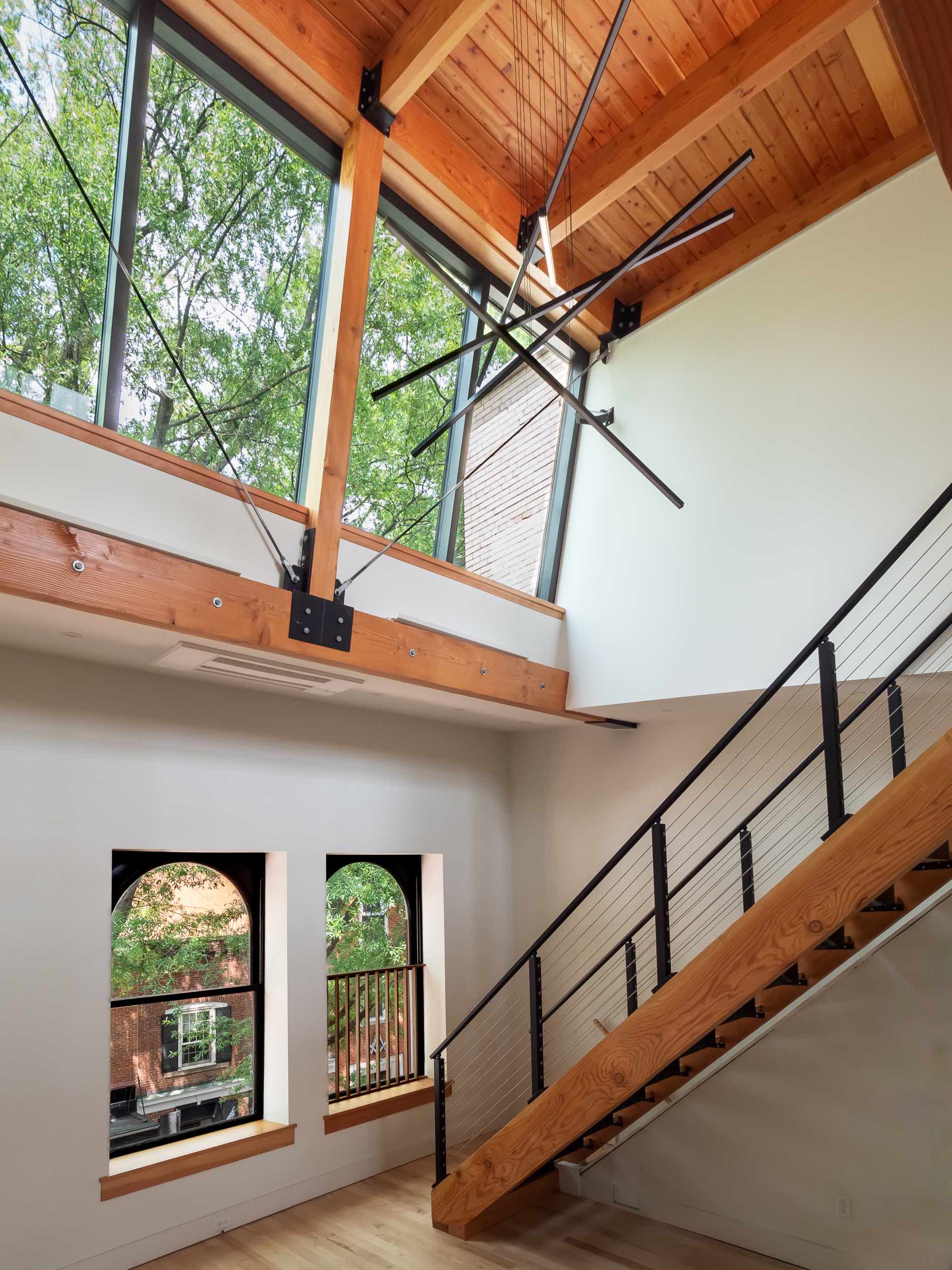 Stair Window and King Post Truss | Charlottesville Loft Apartment | PARABOLA Architecture | Kevin Burke Photography | Copyright 2023