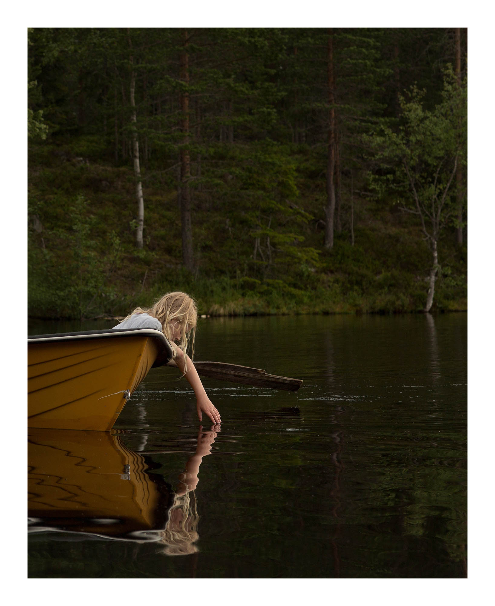 I went to this lake with Swedish artist and composer Frida Hyvönen to take pictures to her album Kvinnor och Barn (2016). When we arrived to the lake we met some children there. I asked if I could photograph this young girl. The image became the cover to the single Sjön. © Elin Berge / MOMENT