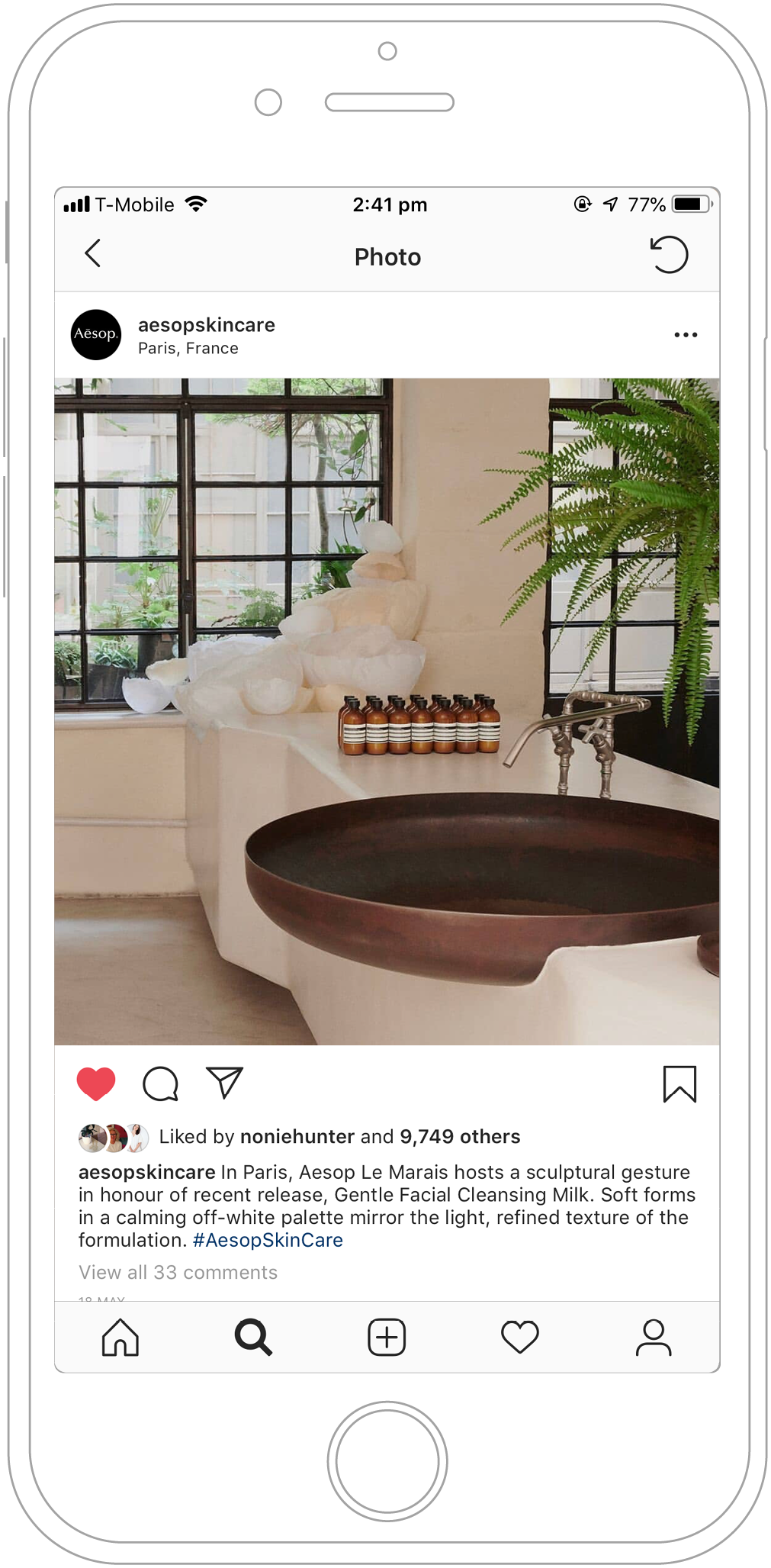 A phone screen showing an instagram post of the oversized demonstration sink at Aesop Le Marais, Paris.