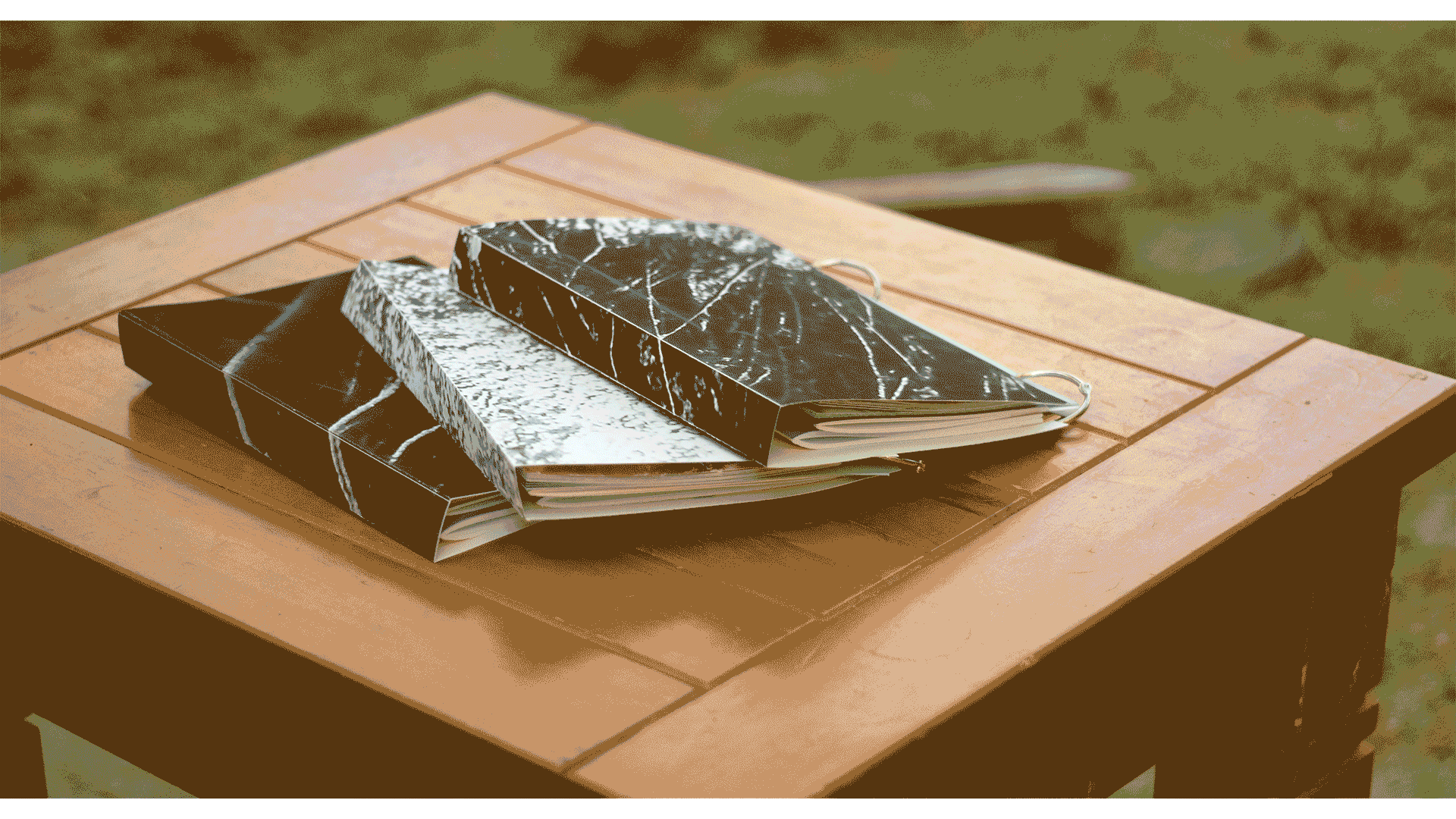 Gif in landscape displaying a book comprised of four smaller books bound with rings. The pages are being flipped through in choppy slides.