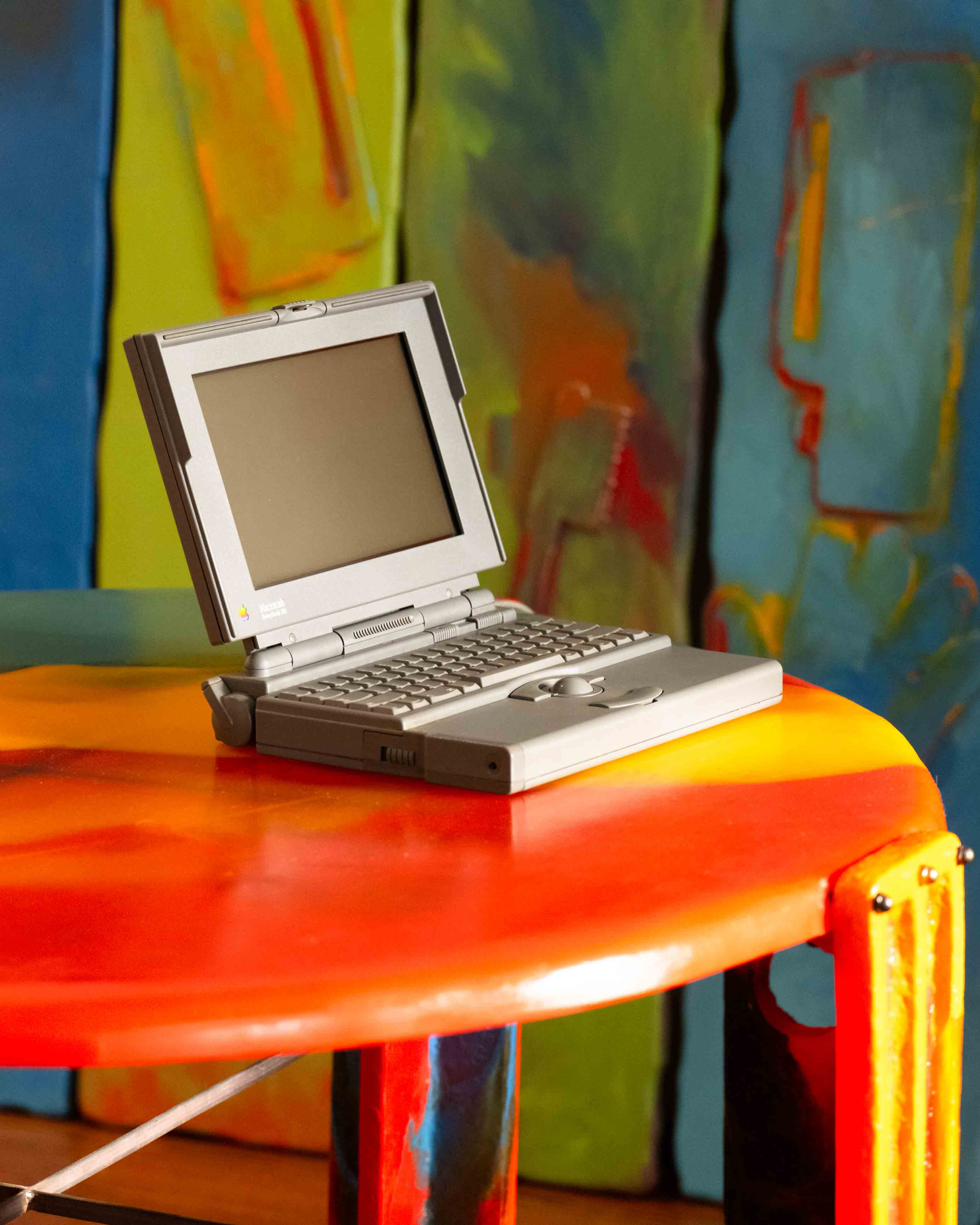 Mac powerbook 180 photographed on top of the Waffle table designed by Gaetano Pesce for the 1994 tbwa/chiat/day office in New York City, presented by sweeterfat in the work/life imbalance exhibition July 1st 2025