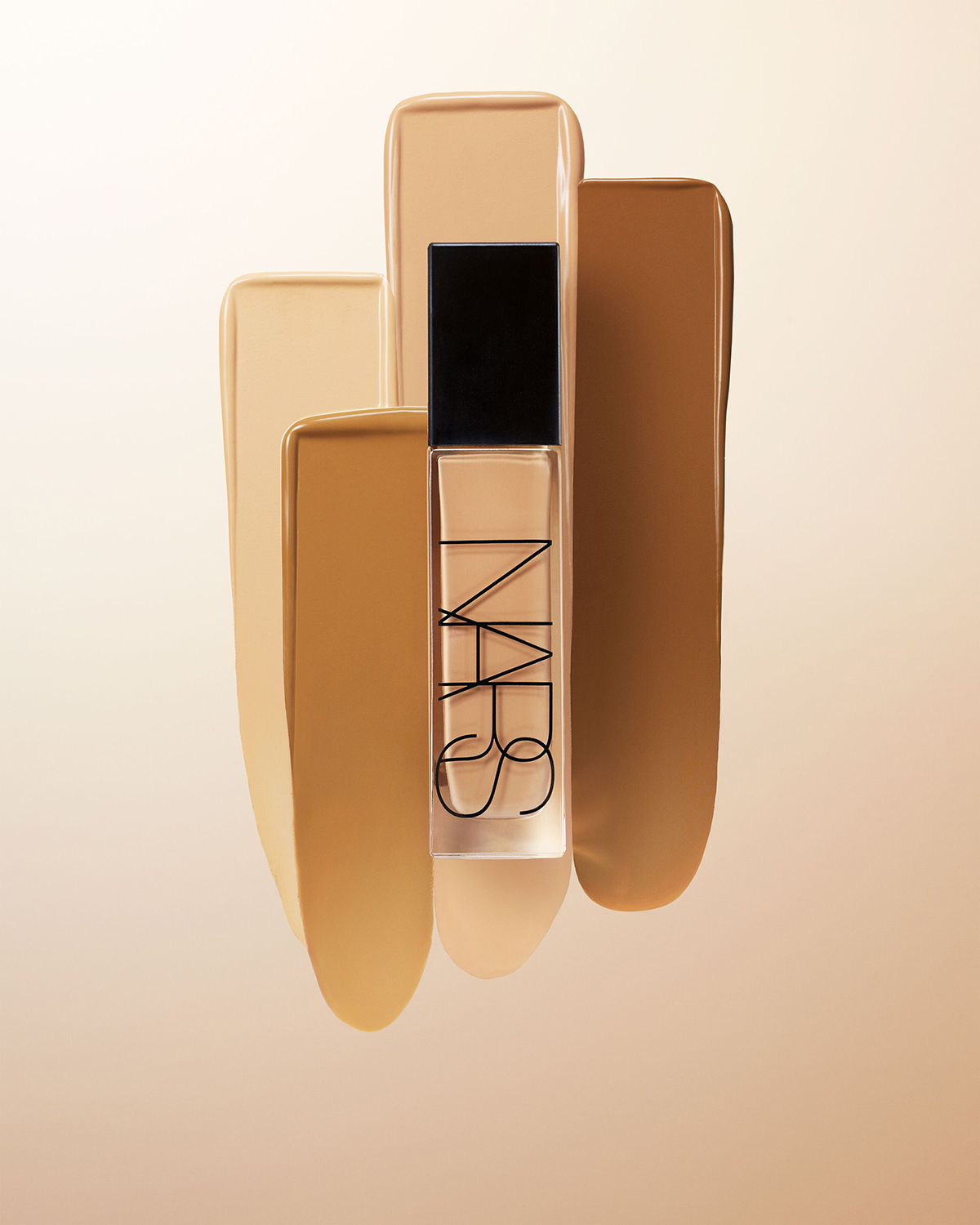 KMA stylist Rachel Haas designs set for photograph of foundation swatches in many different shades for NARS including bottle