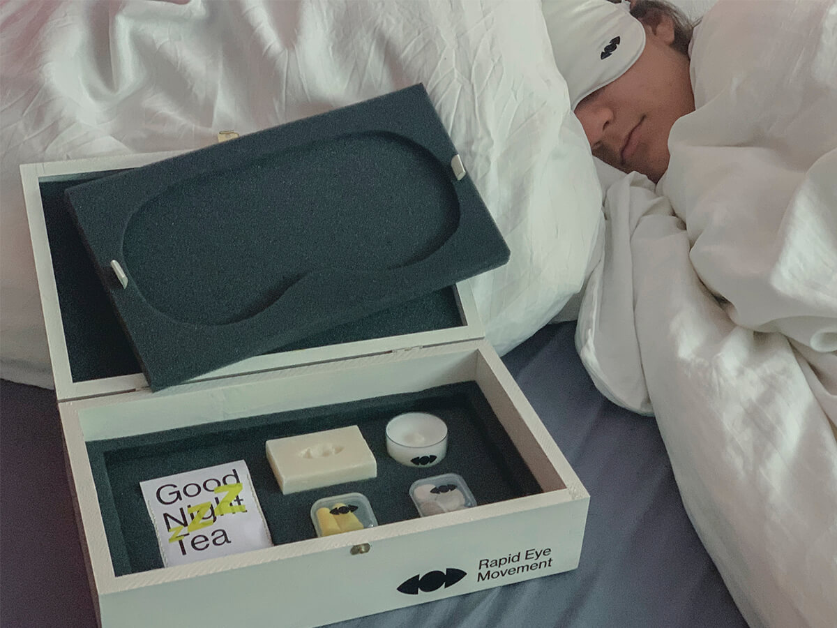 Girl sleeping in the bed, in front is the opened sleep kit