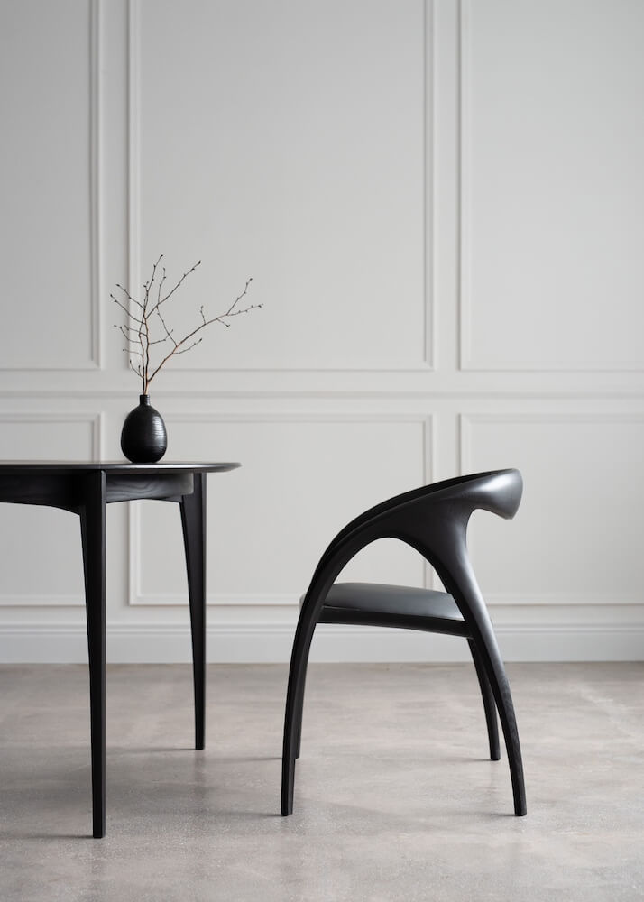A black wooden table and dining chair