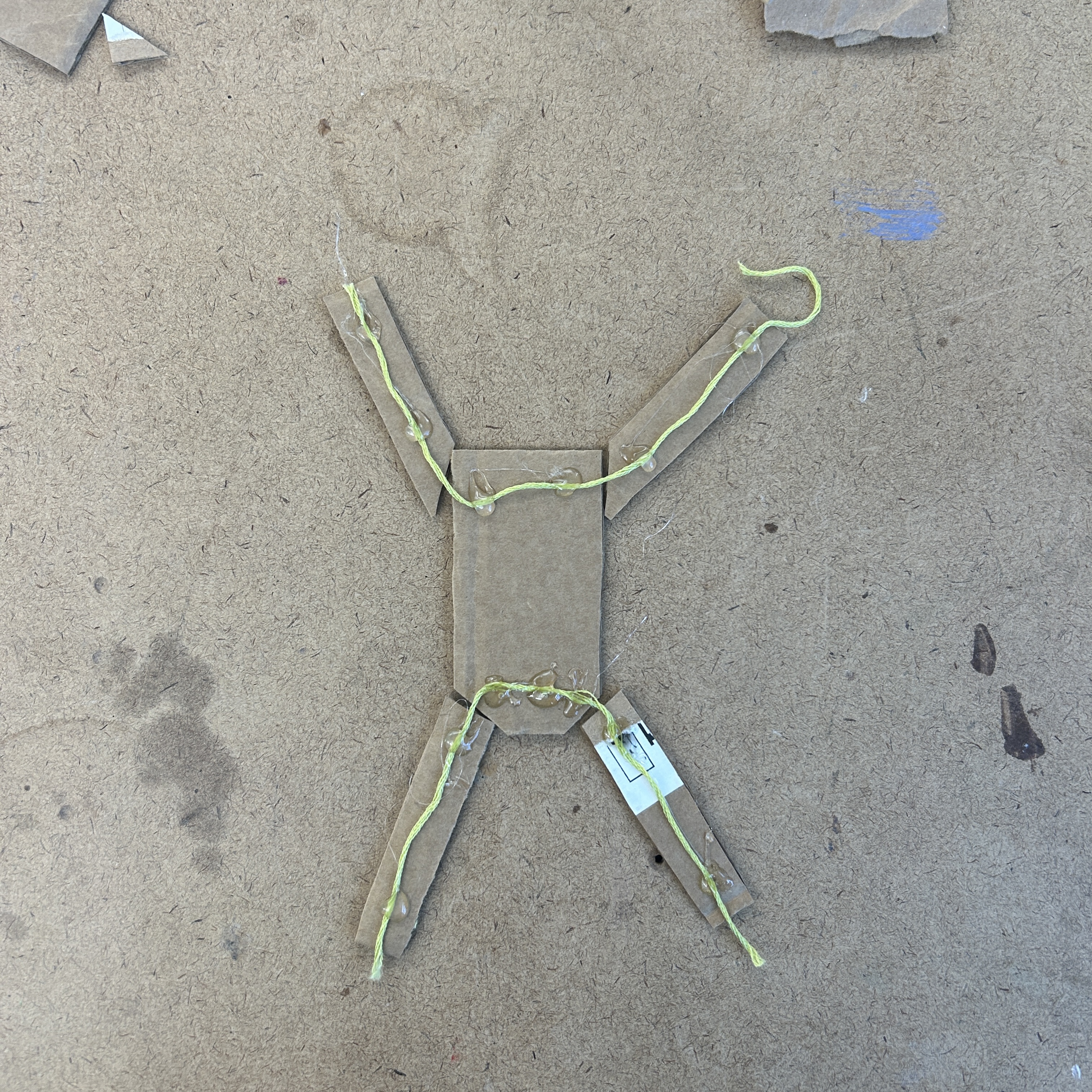 Built Alice out of cardboard pieces held together loosely by string so each limb can move independently.