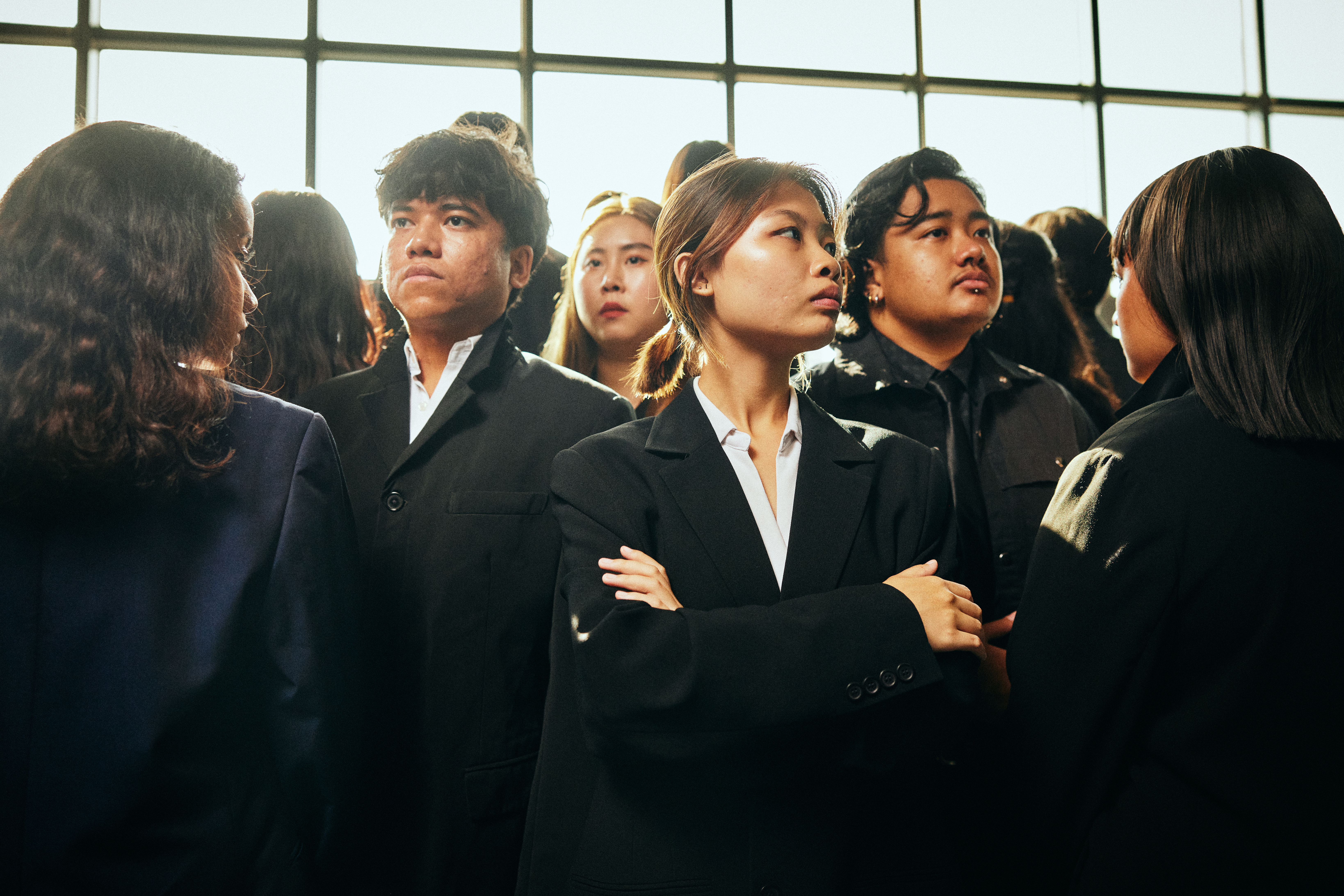 Image 2 of 7: A crowd of Asian youths