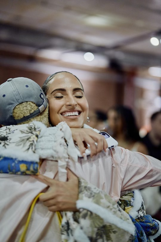 Pharrell huging Joopiter Auction guest