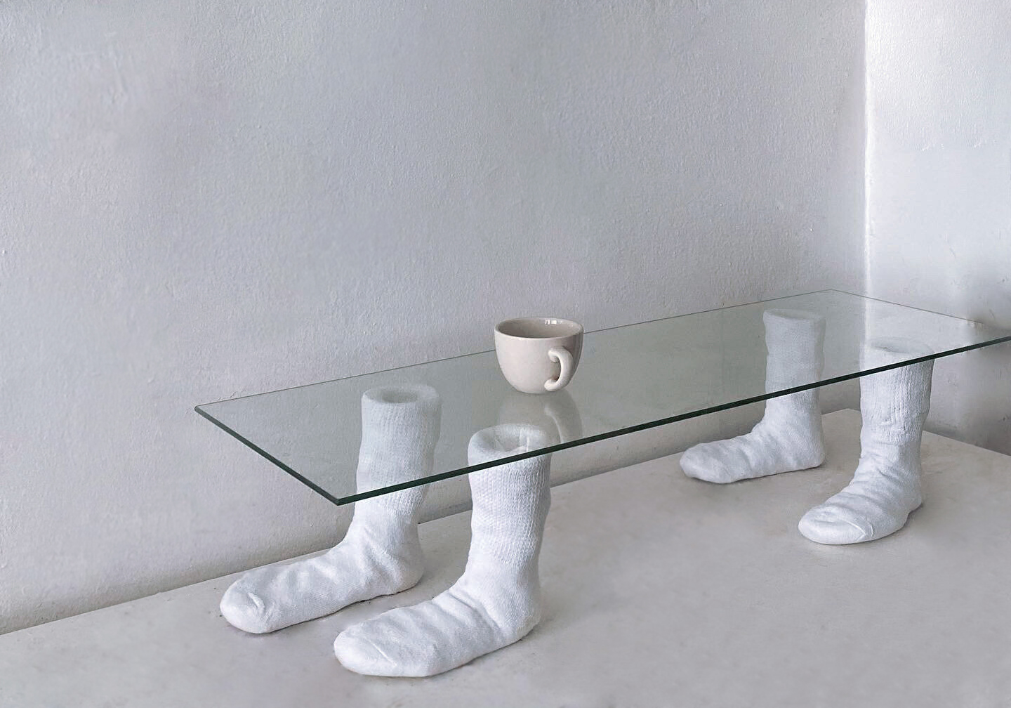 Intersection of coffee table and labor. 2020. 1 x 3 ft. US 8 / EU 38.5. Found glass, wire, plaster, cotton.