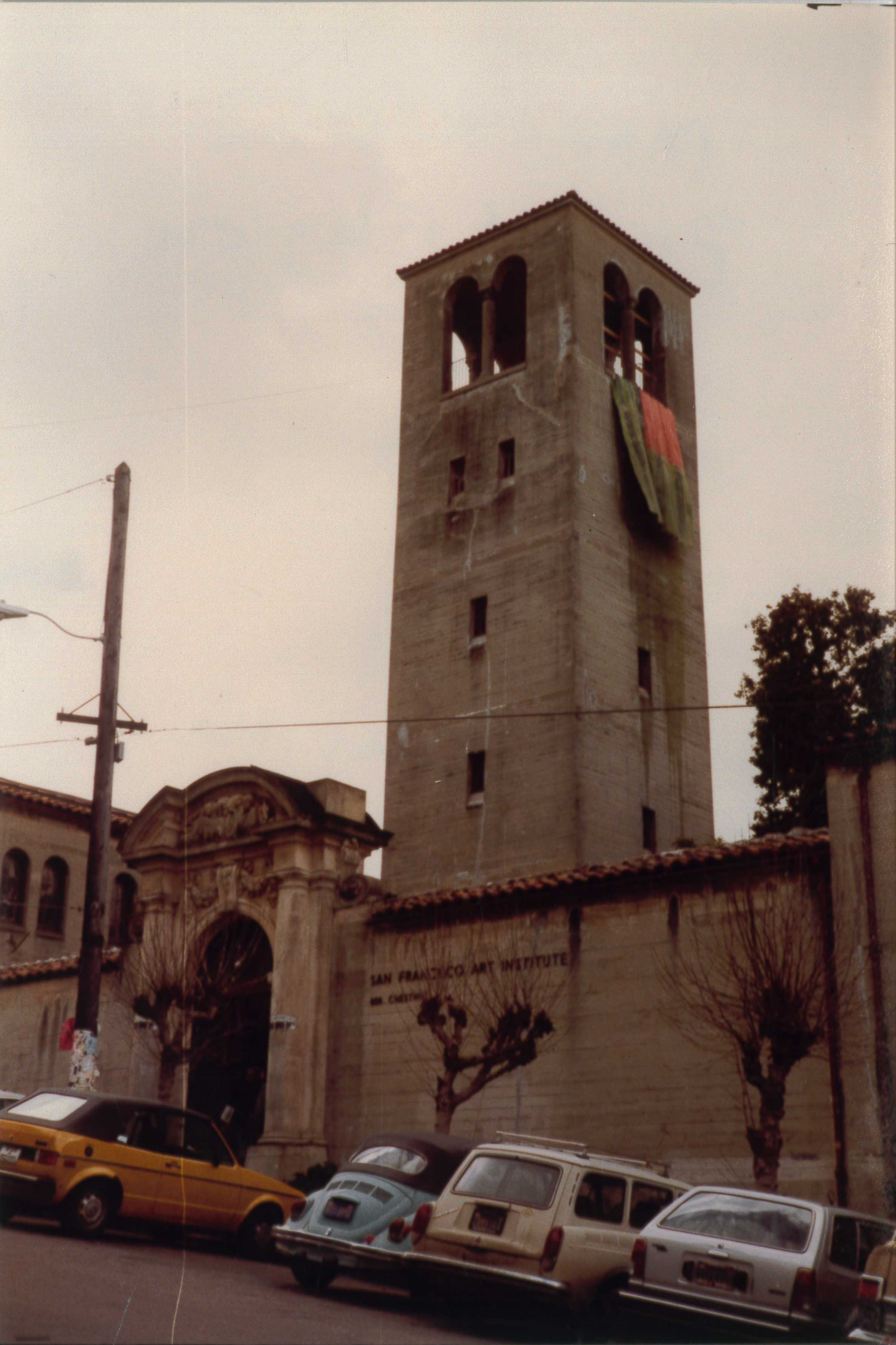 In March 1983 students hung a flag from SFAI’s tower protesting against Ronald Reagan and Queen Elizabeth II’s visit to San Francisco. Protests happened around the city with a large gathering in Golden Gate Park.