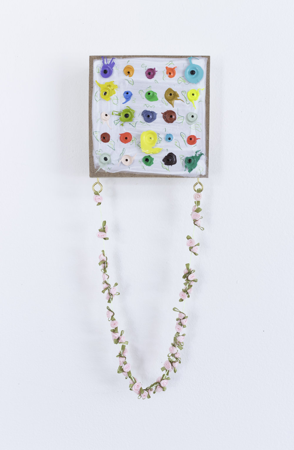  Left Over Flowers, 2018, 16” x 5.5” x 1.75” Pine pegboard, acrylic, prismacolor pencil, thread, rosettes, brass and eye hooks