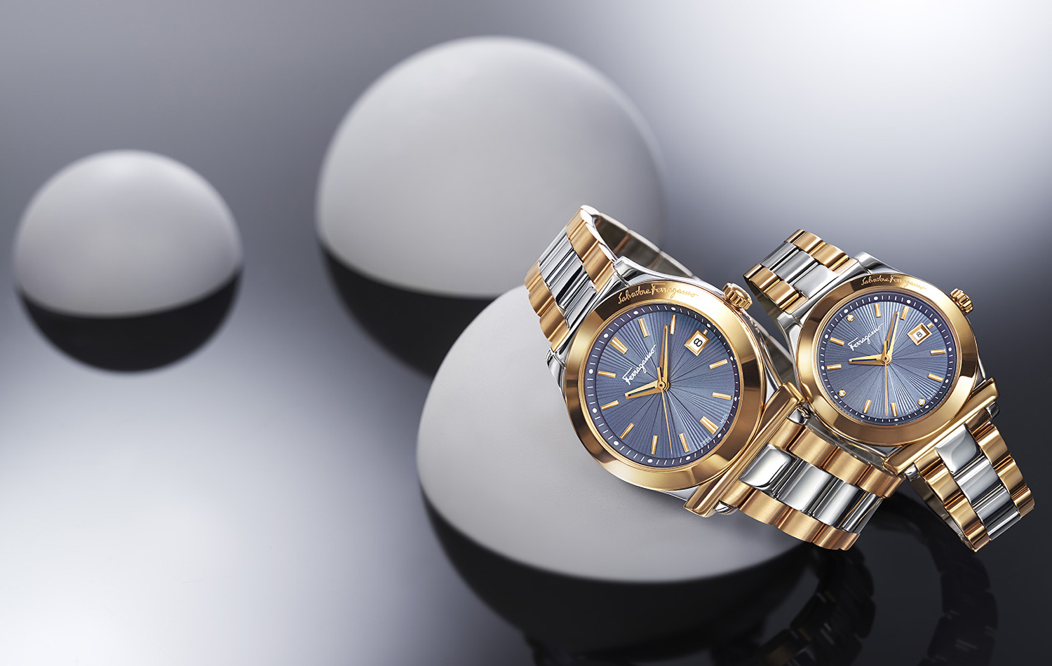 KMA photographer Daniel Schweizer photographs silver gold and blue watches draped over white dots for Ferragamo
