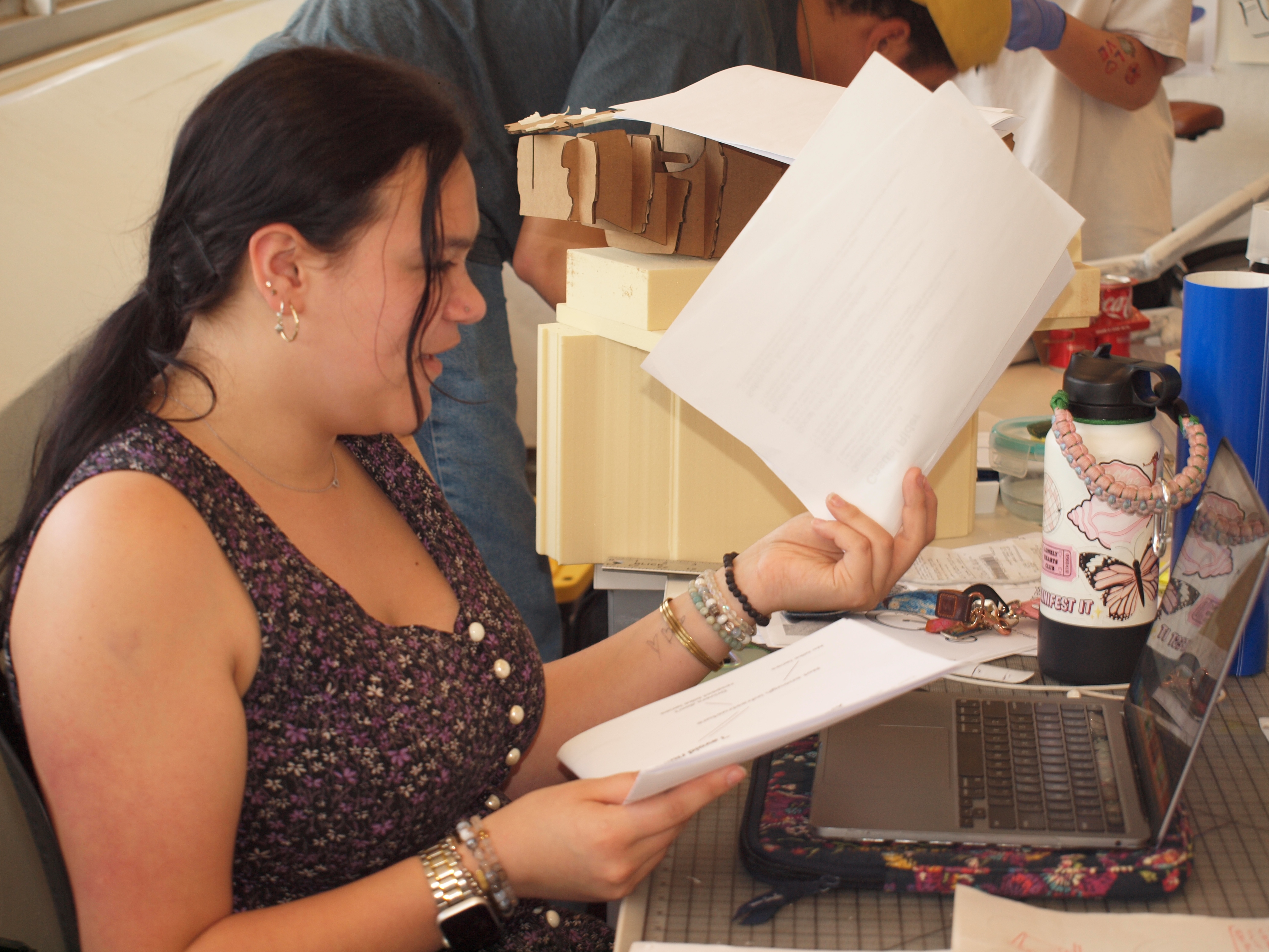angela meticulously sorting through hundreds of ideations to scan in for our visual collateral