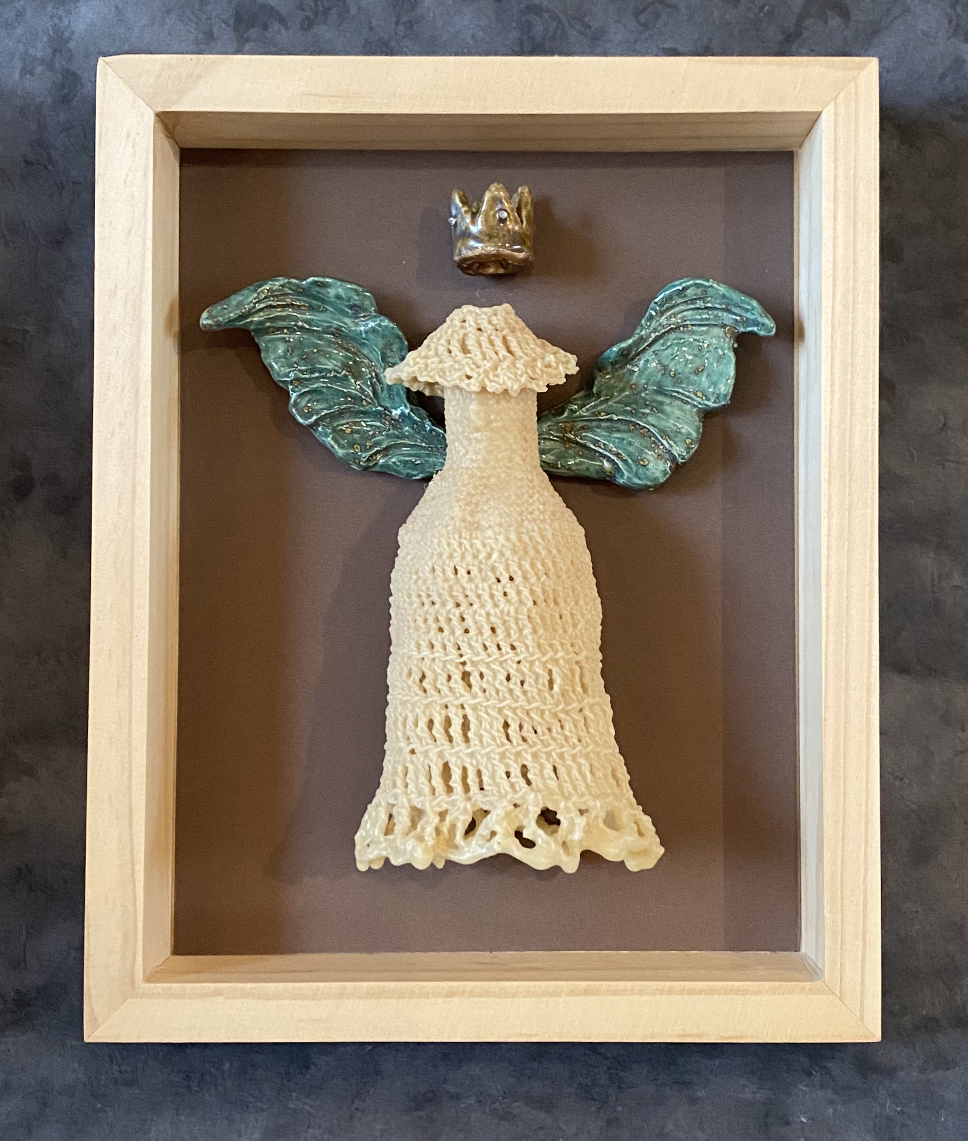 Untitled → porcelain, crochetted and onion skin dyed yarn, felted wool, beads