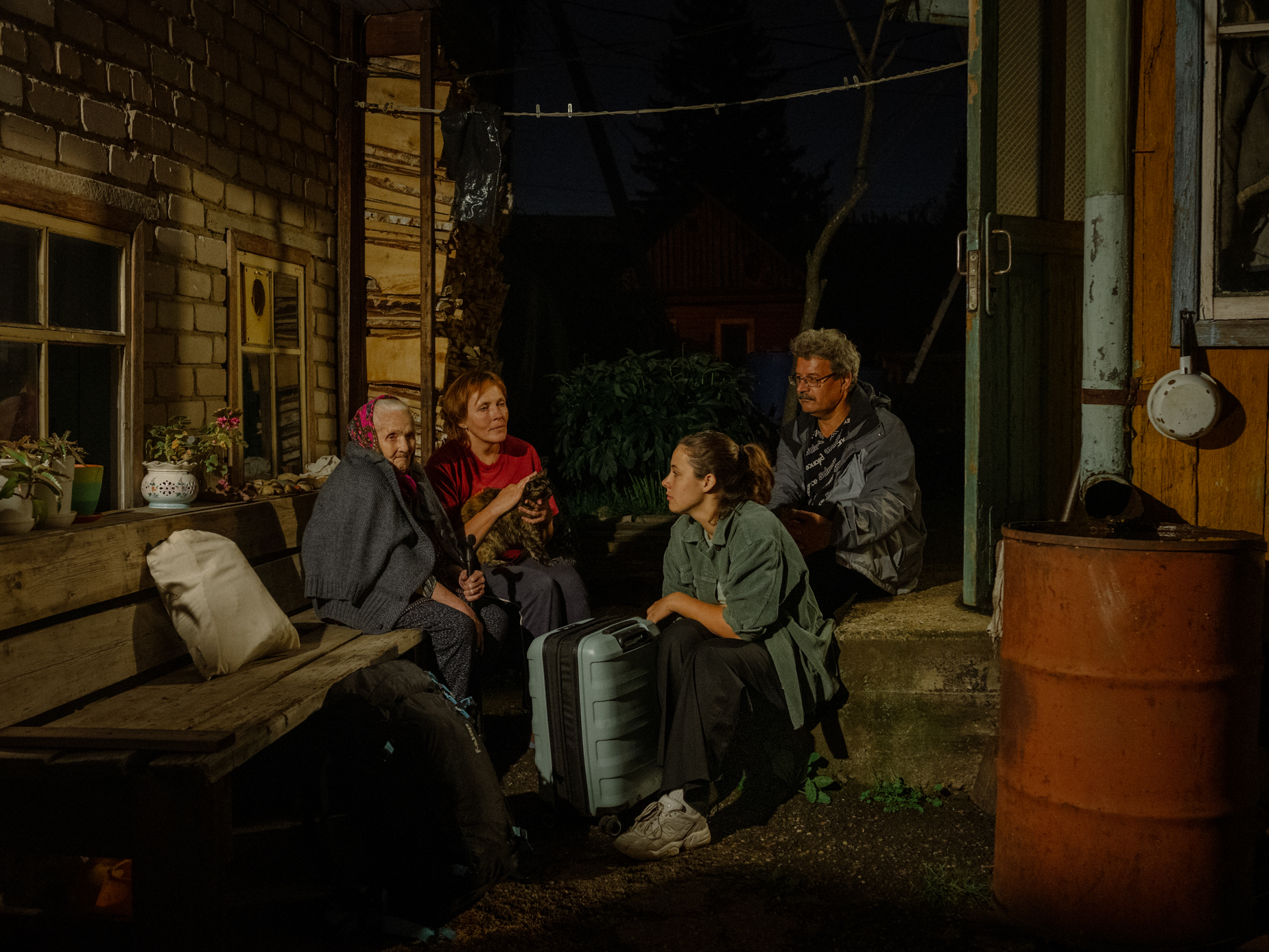 I took this picture of me with my parents and grandma on the porch just before I got on the bus to the airport. I love this Russian tradition of „sitting on the road.“. You all sit down together for a minute to think about what you leave behind. It was the last time I saw them. - Tomsk, 02.09.23