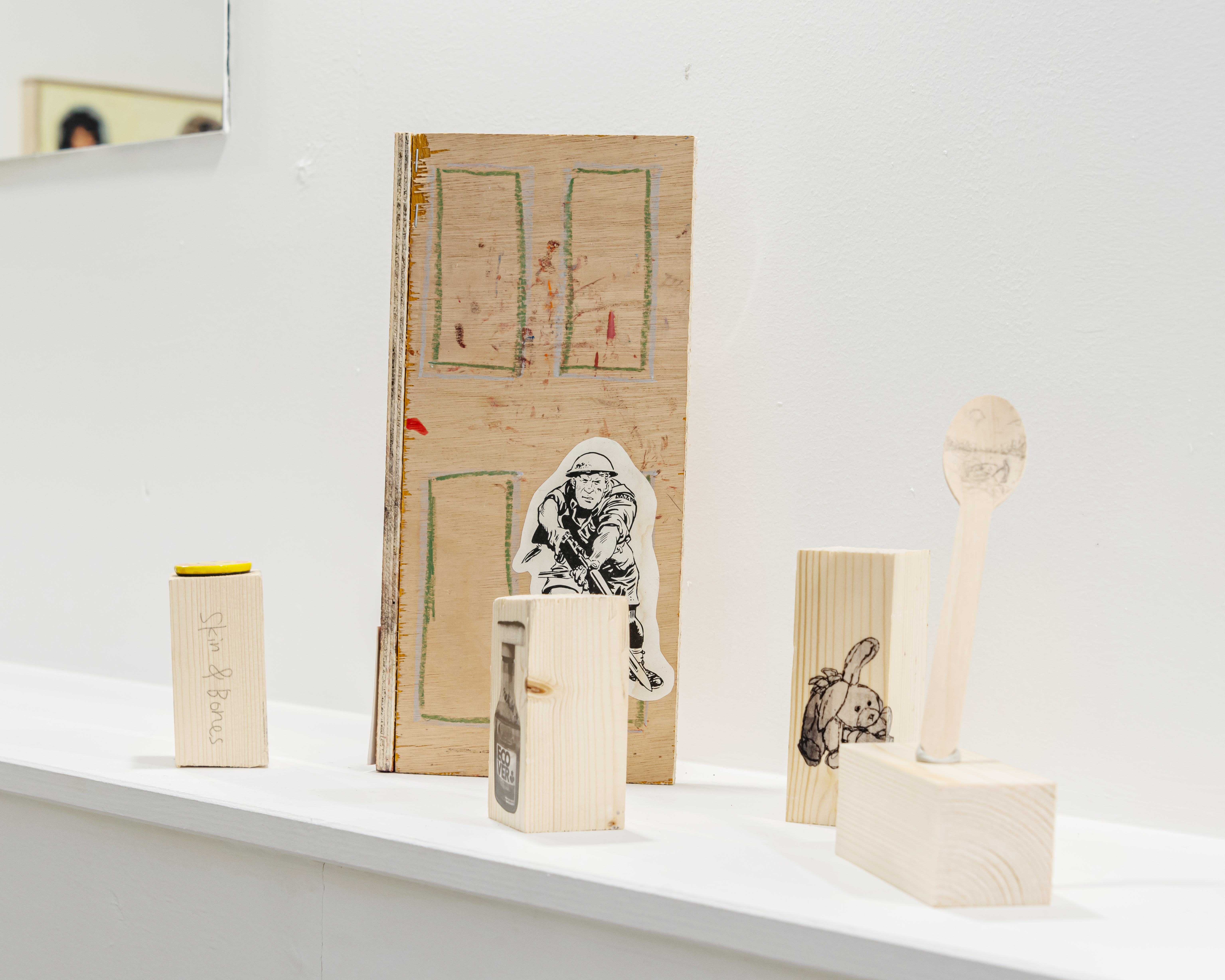 Small City, 2023, Natsuki Iwamoto and Jacob Clayton, 50x30x29.5cm. Including (from left to right): A) A Piece Of Pine [Skin and Bones], (NI) 2023, pencil on pine, 8.5x4x4cm, B) Get Converted, (JC) 2023, found object [pin], 3.5x3.5cm, C) Adventure door, (JC) 2023, photo-cut-outs & oil stick on ply, 29.5x17x6cm, D) A Piece Of Pine [Laundry Detergent], (NI) 2023, acetate print on pine, 11.5x4x4cm, E) Untitled [Pier], (NI) 2023, pencil and tack on timber, 18.5x11x4cm