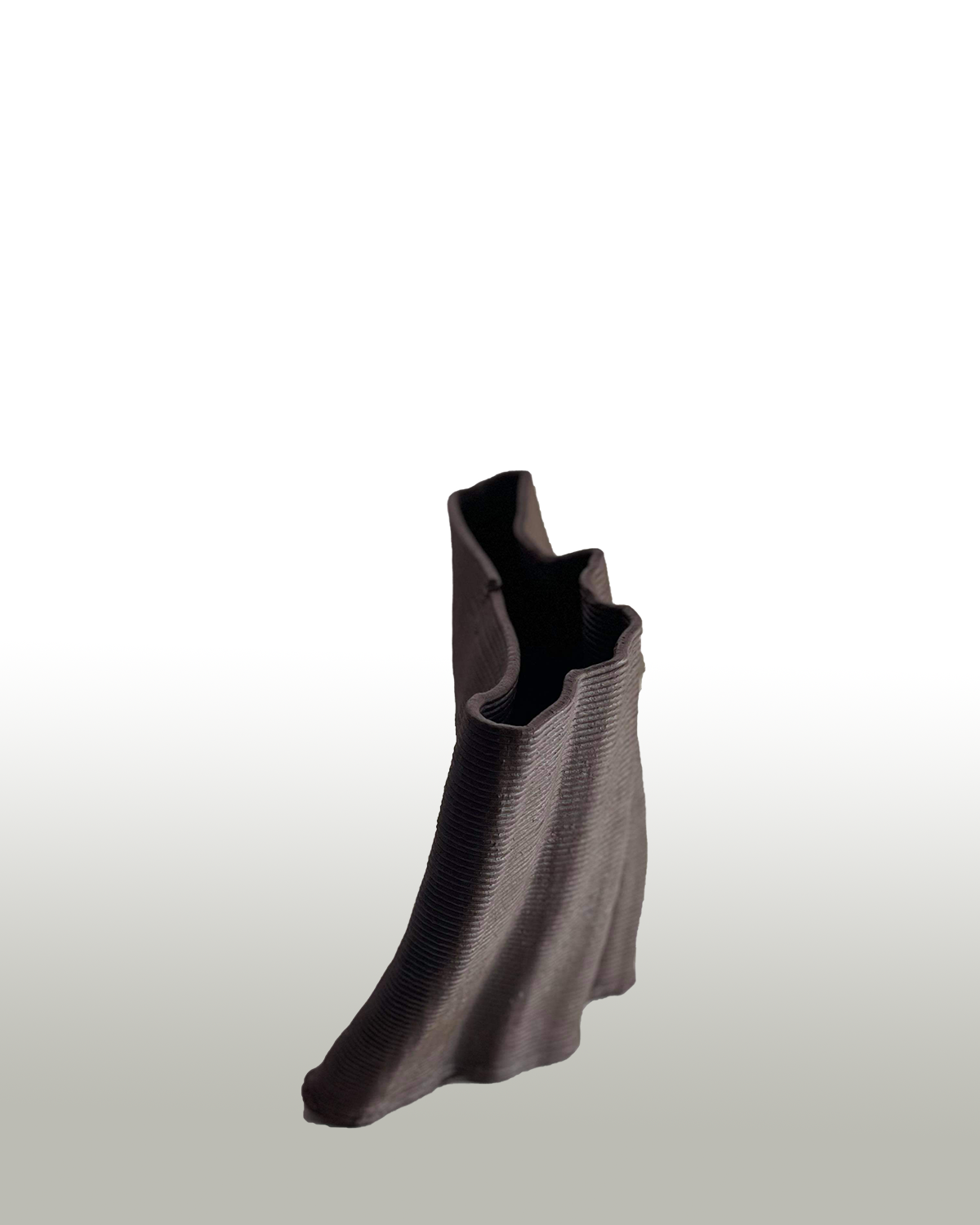 a wavy red-brown vase stands on a white to grey gradient
