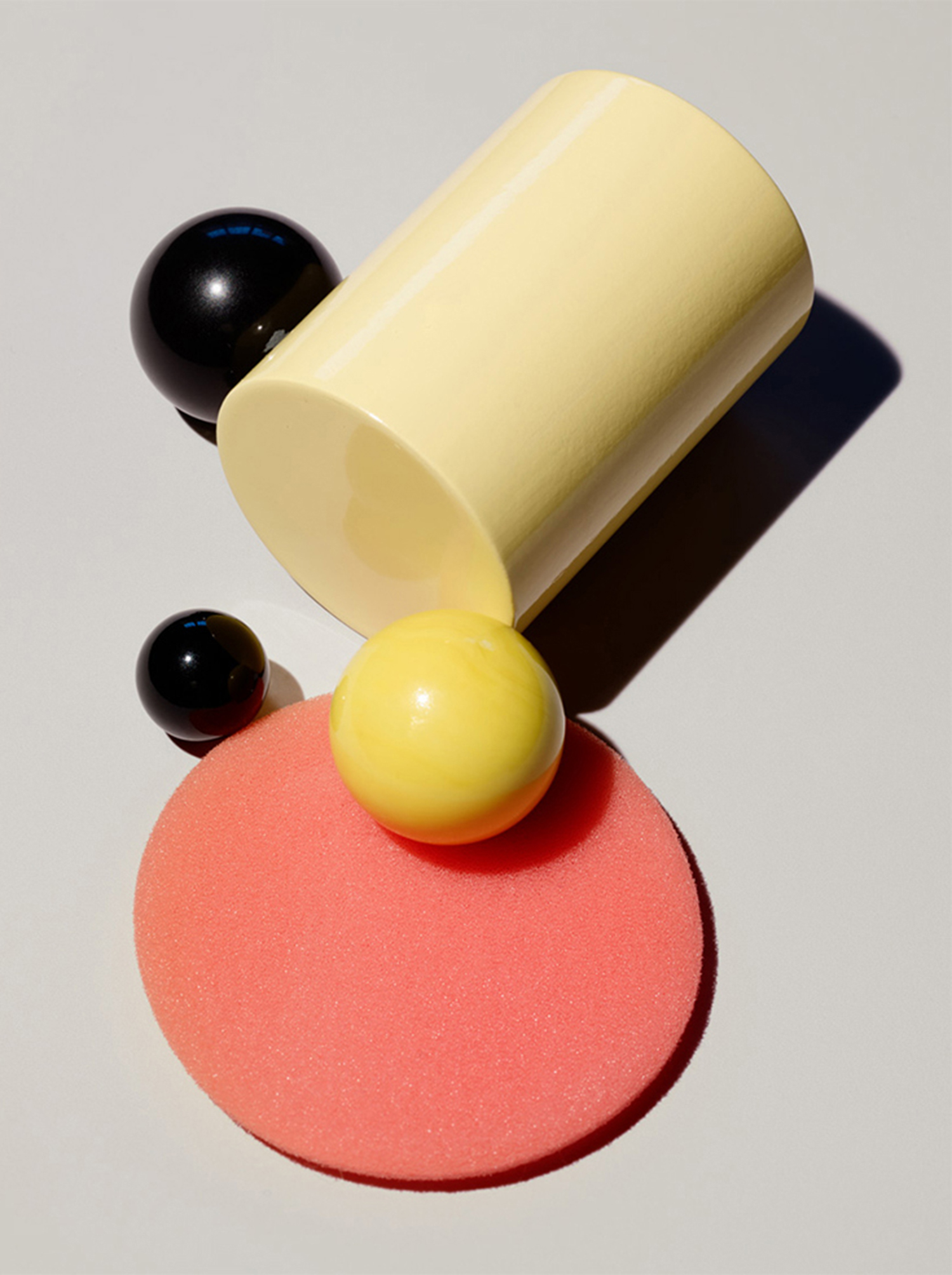 KMA stylist Sara Wacksman designs set for an abstract photo of colorful glass beads and other objects with a white background