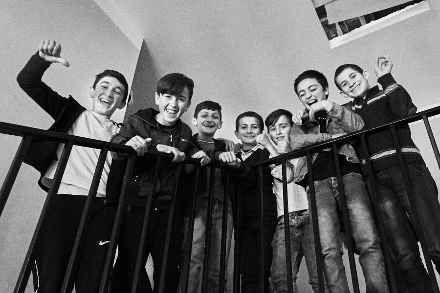 Bachano and his friends smile on the staircase as they're about to take recess break. Because of the small population, some of the villages only have primary/elementary schools. May 2018