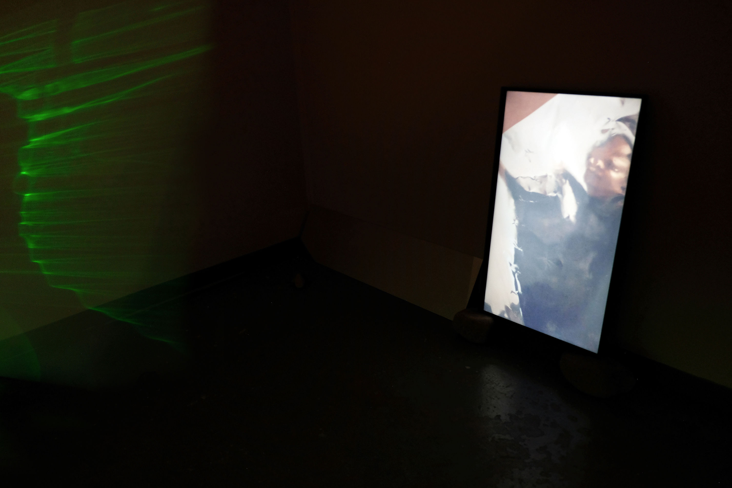 perception is memory is perception is..., detailed view, 2-channel video projection, mylar, mirror, fan, and rocks 2017. Photo credit: Erica Robert Pallo
