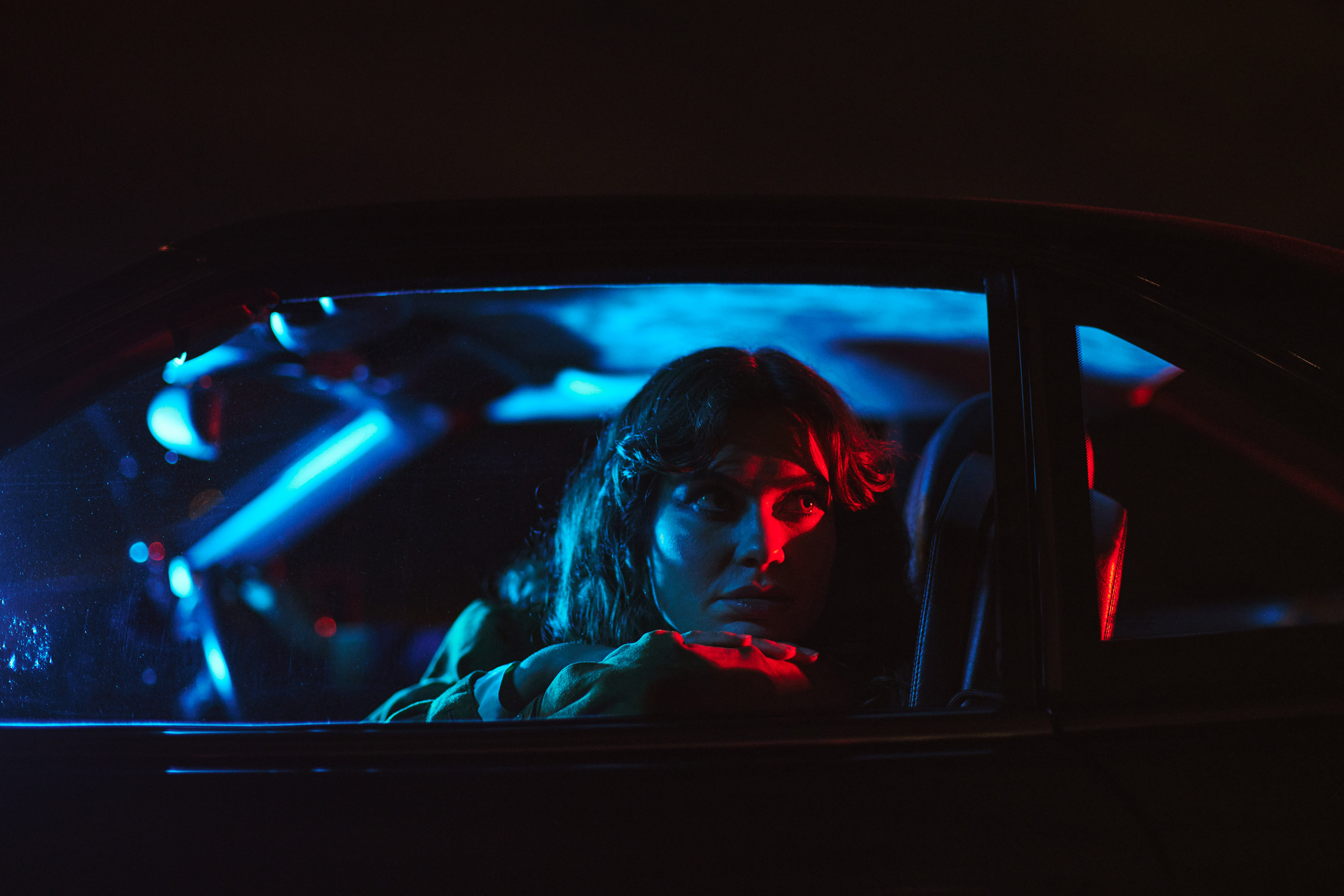 A story of young love in the suburbs told through photography, featuring stylish models in vintage clothing, photographed at sunset in Dublin, Ireland by fashion and lifestyle photographer Alex Sheridan. Suburban Love photo series. Featuring a vintage 1993 Mercedes Benz SL class and cinematic lighting and red light. Euphoria inspired photoshoot.