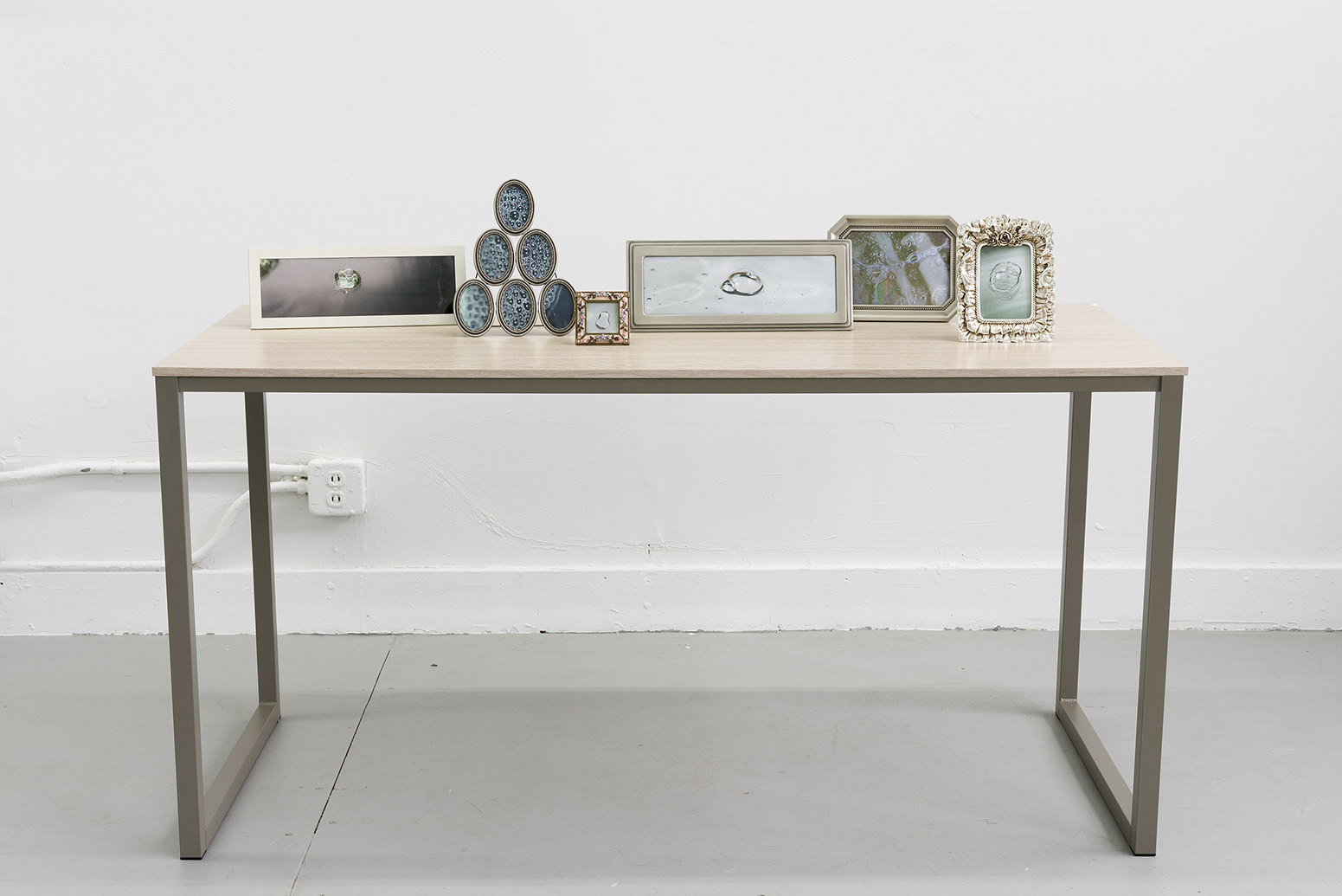 nuit de cellophane, 2024, prints, frames, table 36 x 55 x 24 in. (91.4 x 139.7 x 61 cm.)