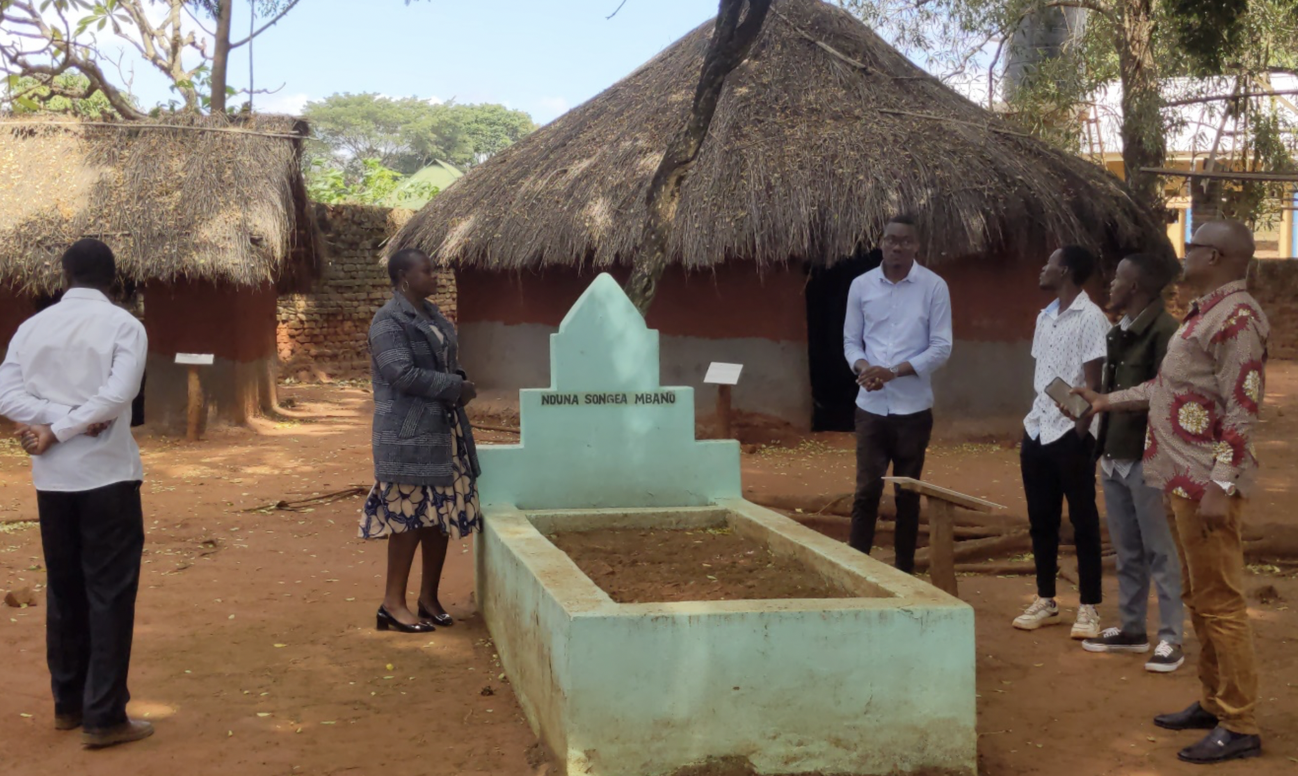 The Maji Maji study group on a tour of the museum facilities, visiting one of the grave sites of the Maji Maji warriors.