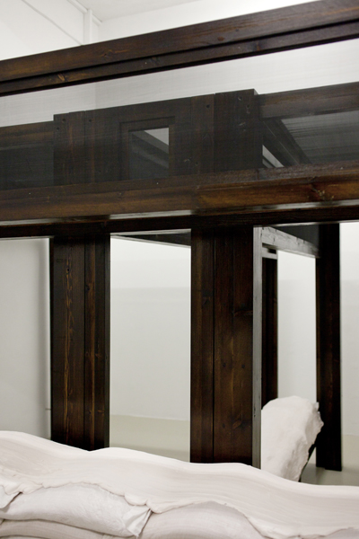 The Contagious Bride, 2012, variable size, wood, stain, screen, sand bags, plaster