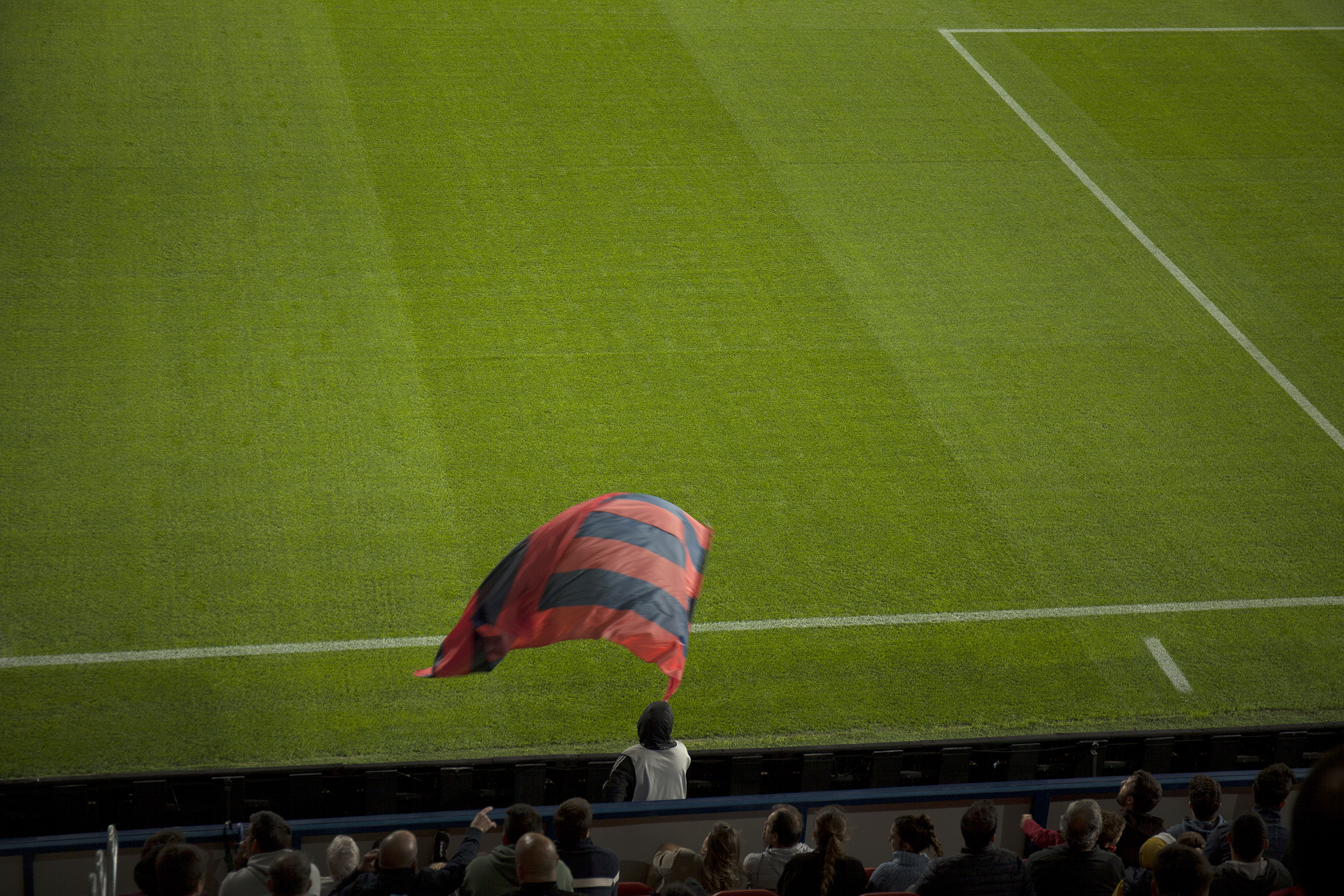 Man waving a flag in El Sadar Stadium Pamplona, Spain, 2022photography, color, single, exhibition