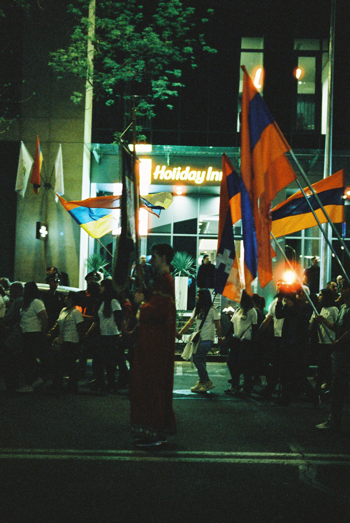 Flags hang everywhere on Remembrance Night. Cinestill 800T.