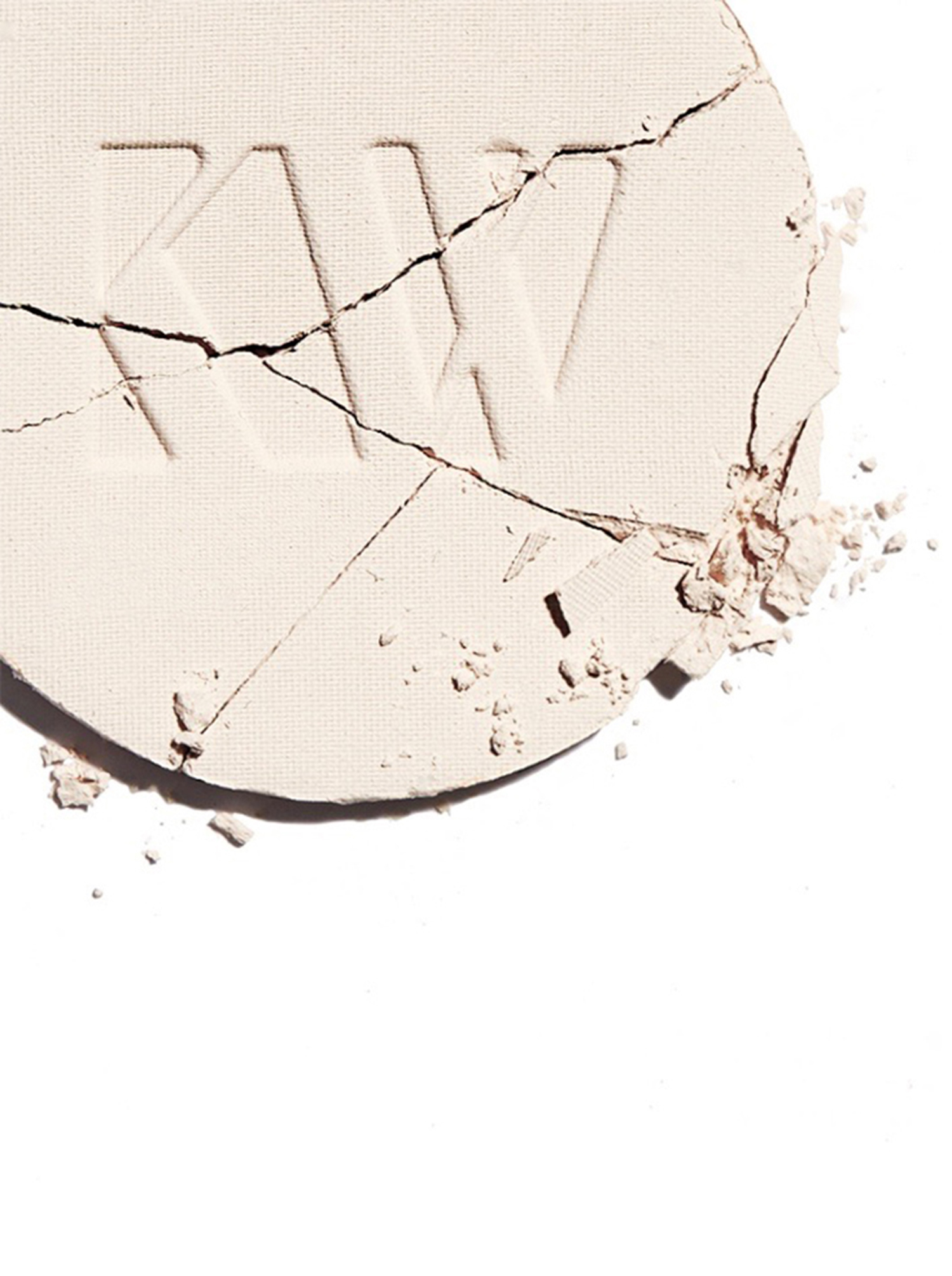 KMA stylist Sara Wacksman designs set for photo of light Kjaer Weis powder foundation crushed against a white background
