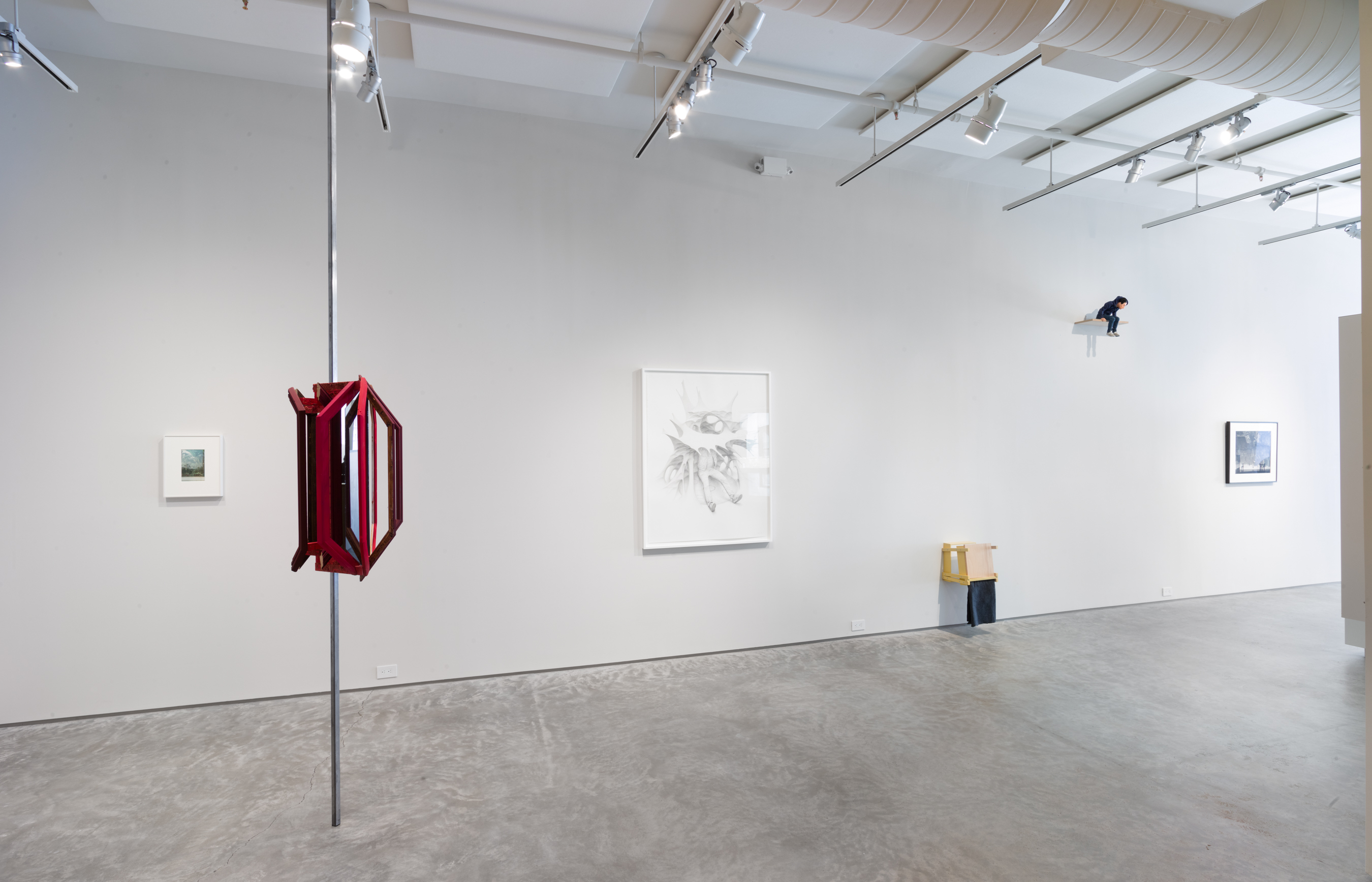 Installation shot, YOU STAND ON THE GROUND FLOOR curated by Harriet Salmon and Jesse Penridge. From left to right: Luigi Ghirri, Parigi, 1978. Vintage C-print, 15 x 12 1/4 inches. Heather Rowe, The Entity (Red Mirror), 2017. Frame, one-way mirror, grey mirror, wood, fabric, paint, steel, 24 x 24 x 36 inches (pole height 13'6"). Jean-Pierre Roy, Spin Network II, 2018. Graphite on paper, 53 x 41 1/2 inches. Adrian Meraz,Blank (toggle twins), 2018. Wood, felt, paint, screws, 27 x 13 x 16 1/2 inches. Maurizio Cattelan, Mini-Me, 1999. Resin, rubber, fabric, hair, metal, plastic, and paint, 15 x 8 x 10 inches. Abelardo Morell, Camera Obscura: Manhattan View Looking West in an Empty Room, 1996. Gelatin silver print, 26 x 30 inches. (Credit: Jason Mandella)