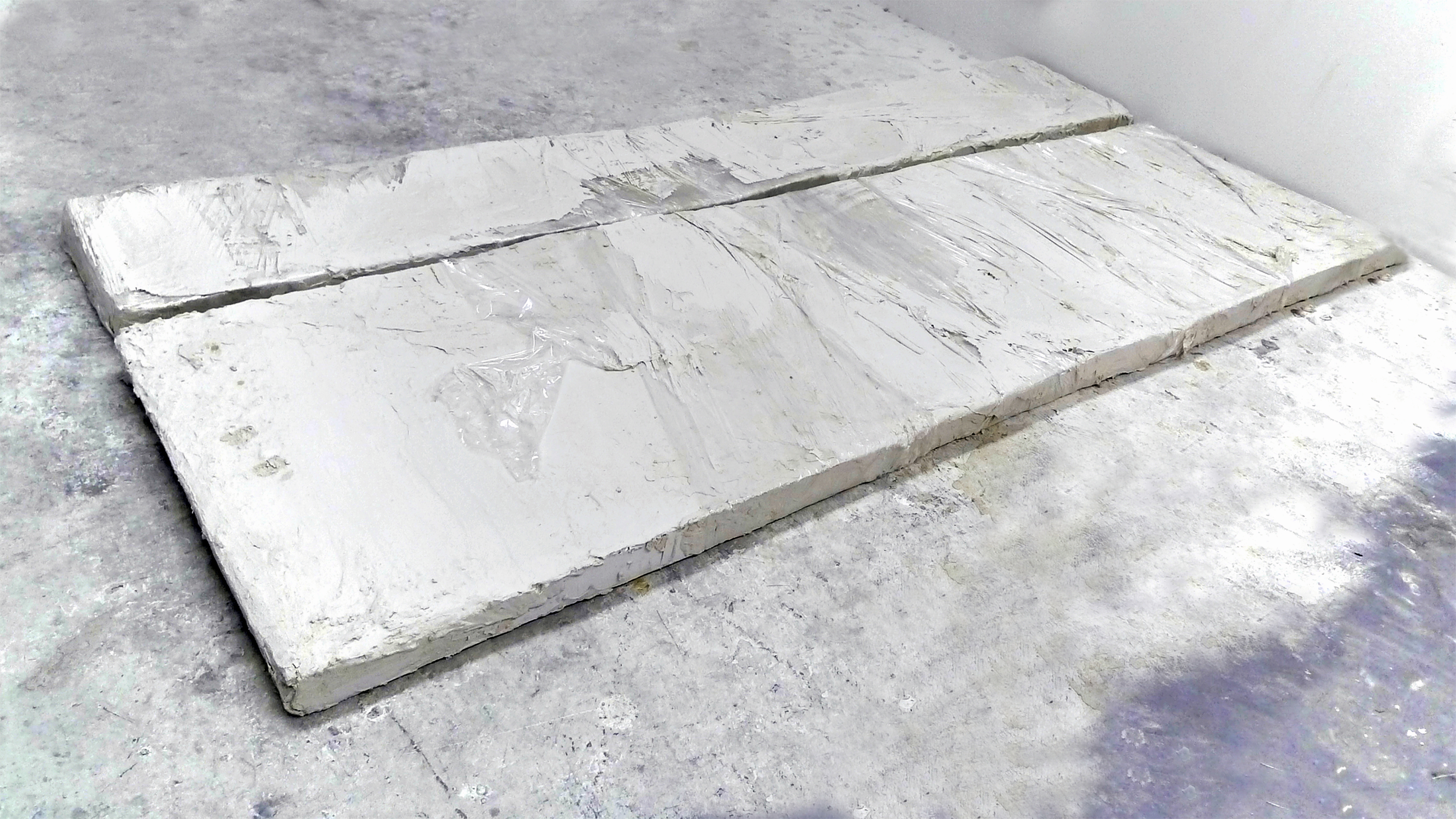 3/11 – EARLY RESPONSE.Foam core, concrete grout, plastic wrap. Approximately 96" x 50" x 3",  2014.