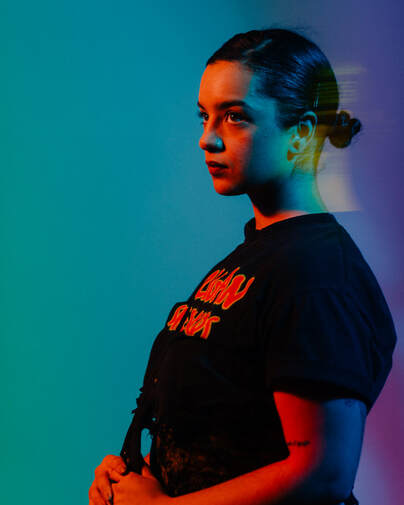 Rixy (she/her) conceptualizes Feminine divinity in their various forms and characterizations. Working primarily through Painting, Sculpture, & Public Art, her tool belt of disciplines help reinterpret stories of agency &ndash; like episodes of a never-ending cartoon. The work often plays on the range of sensual femininity.