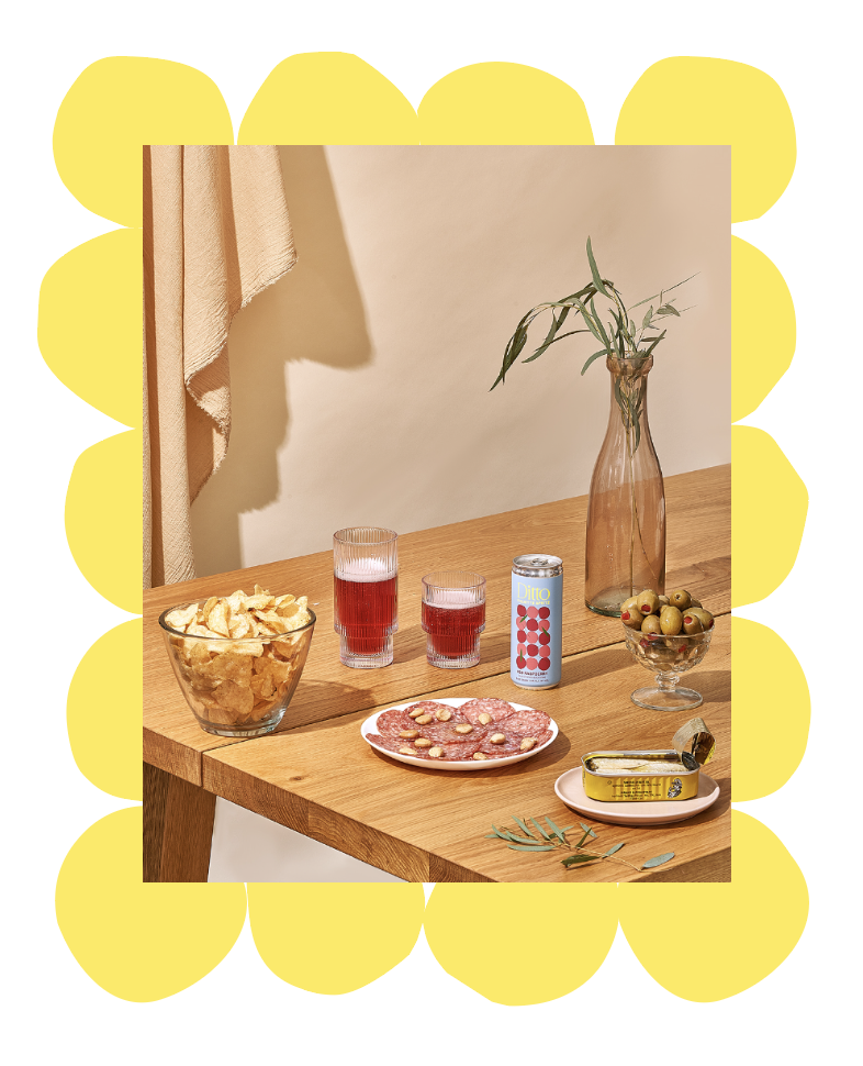 Table setting of Ditto Piquette spritz packaging design and snacks.